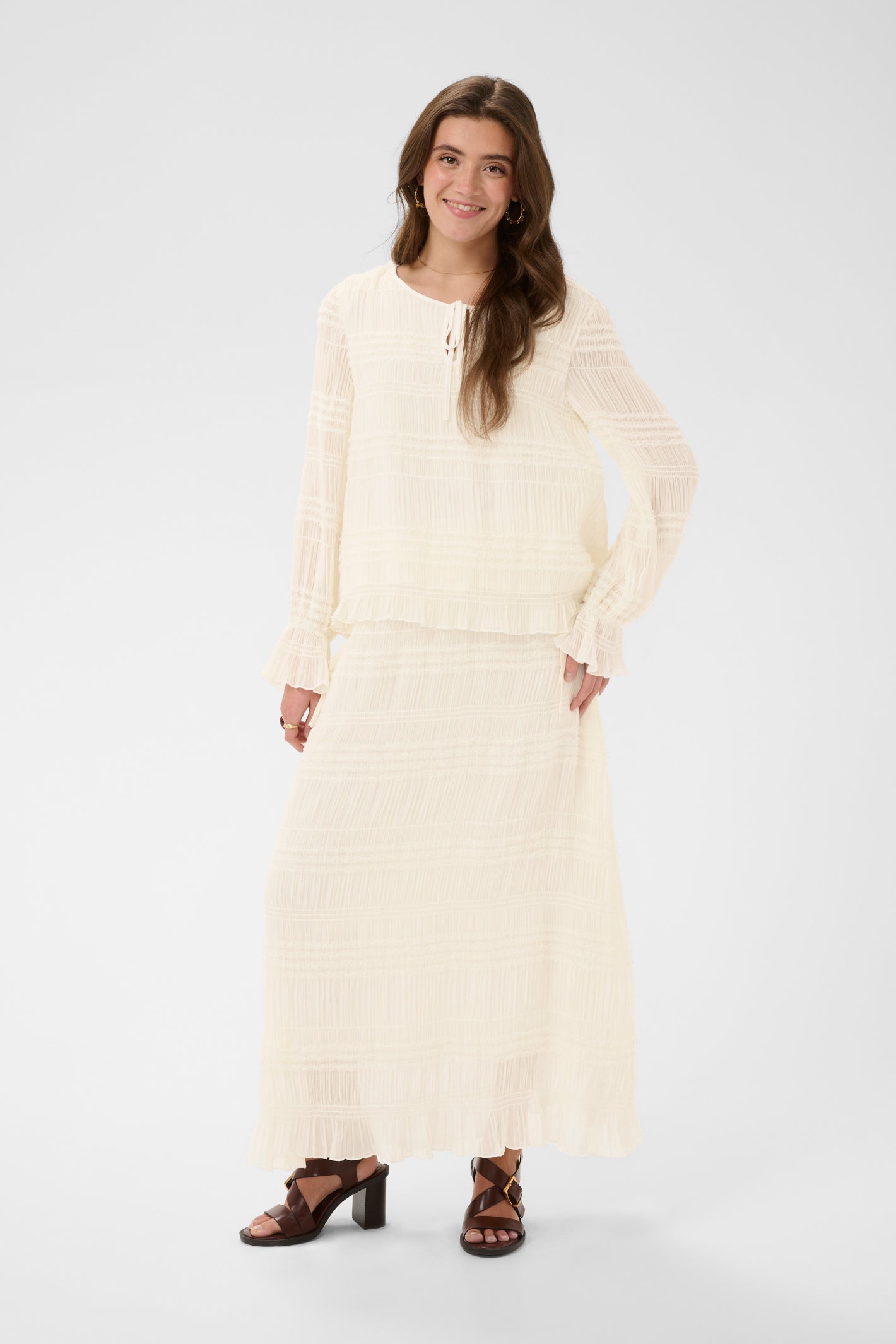 Cream CRSissel textured blouse in Whisper White with tie neckline, layered frill detailing and long ruffle sleeves.