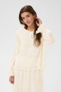 Cream CRSissel textured blouse in Whisper White with tie neckline, layered frill detailing and long ruffle sleeves.