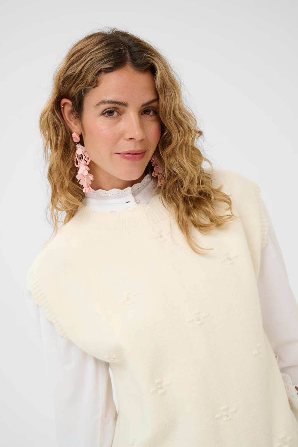 Cream CRAvie knit slipover in whisper white layered over a blouse, women’s sleeveless knit top – Dotique