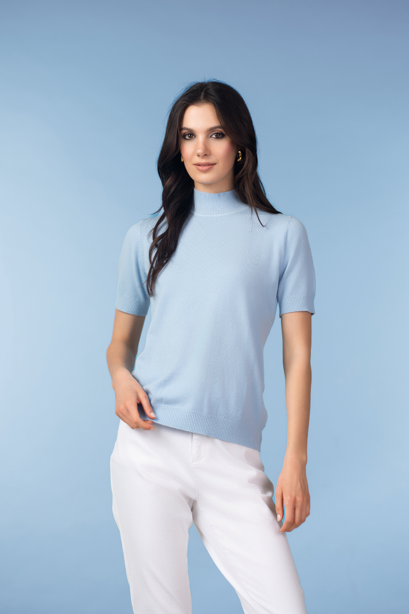 Model wearing Alison Sheri YRE702 Blue Short Sleeve Knit Top in soft blue, shop Alison Sheri at Dotique.