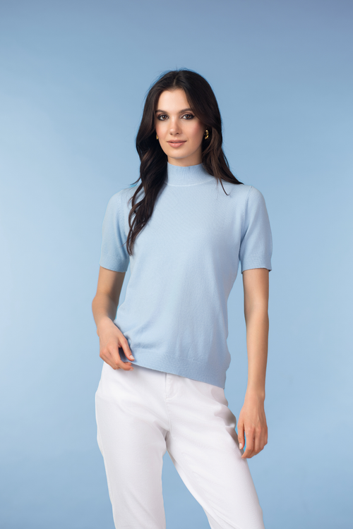 Model wearing Alison Sheri YRE702 Blue Short Sleeve Knit Top in soft blue, shop Alison Sheri at Dotique.