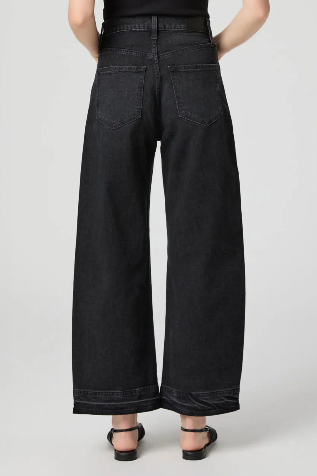 Arellia Ankle Jeans in Black Void — high-rise, ankle-length barrel-leg with raw hem. Soft stretch denim and easy styling for everyday wear. Shop at Dotique.