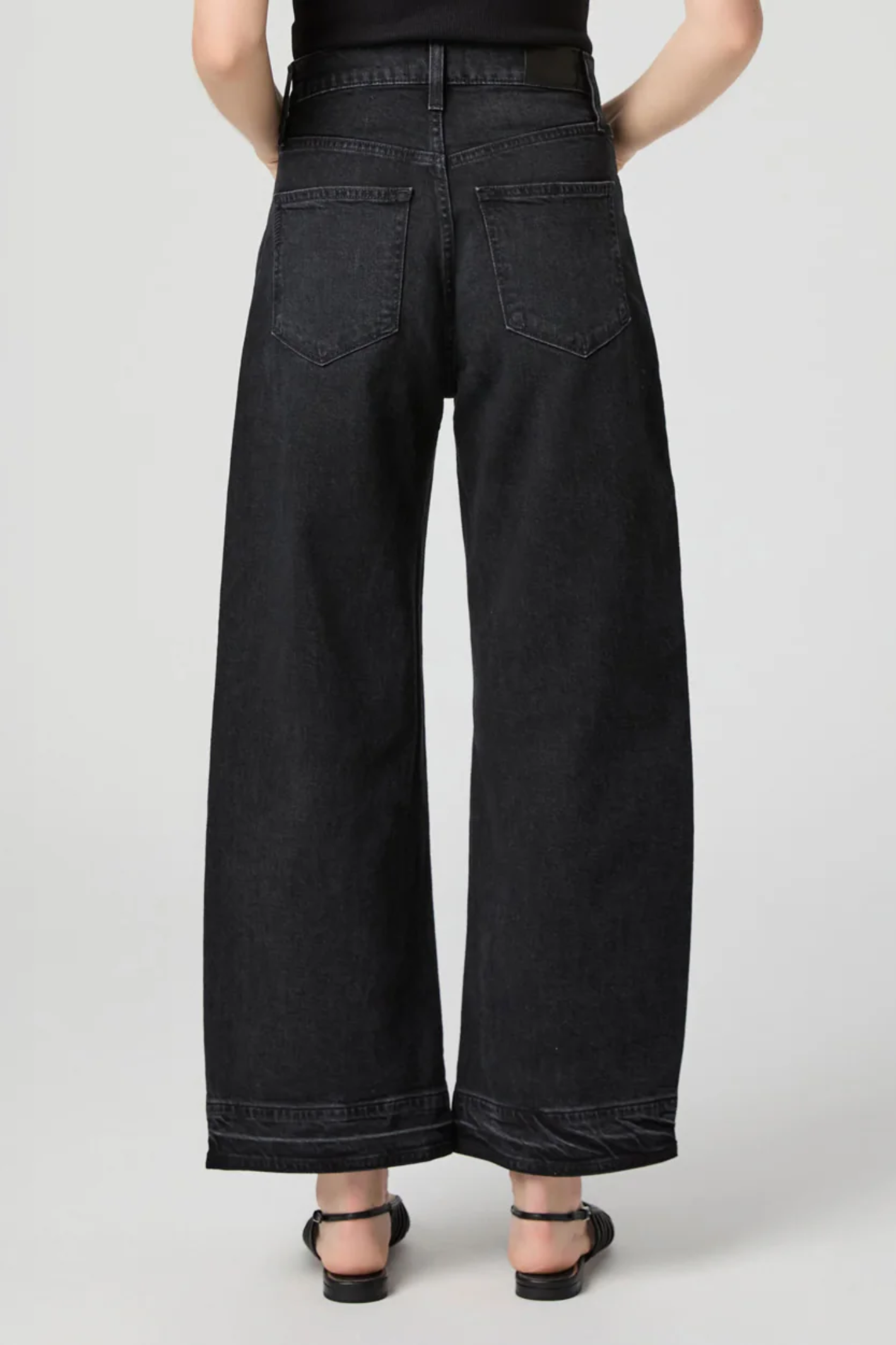 Arellia Ankle Jeans in Black Void — high-rise, ankle-length barrel-leg with raw hem. Soft stretch denim and easy styling for everyday wear. Shop at Dotique.