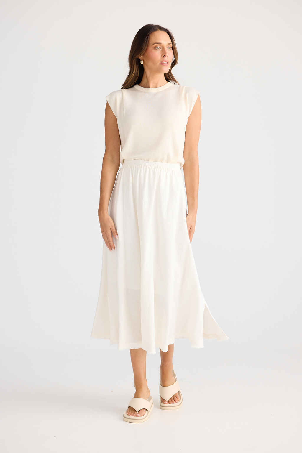Brave + True Oakley Skirt in off white. Bias-cut midi skirt with elasticated waist, side splits and linen viscose fabric. Shop at Dotique.
