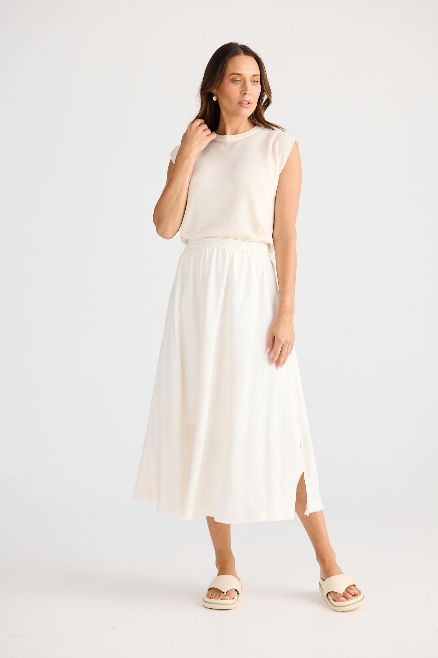 Brave + True Oakley Skirt in off white. Bias-cut midi skirt with elasticated waist, side splits and linen viscose fabric. Shop at Dotique.