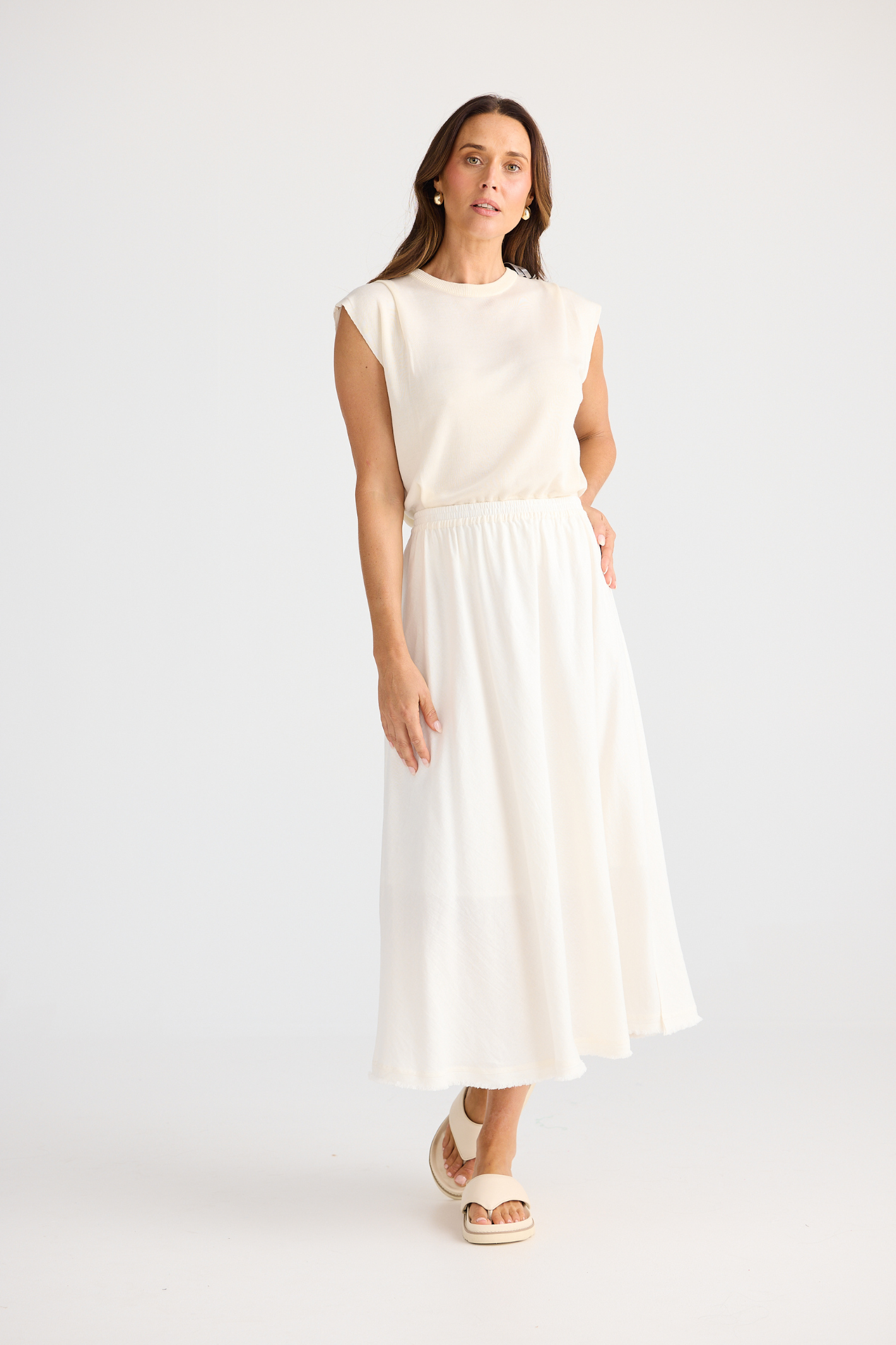 Brave + True Oakley Skirt in off white. Bias-cut midi skirt with elasticated waist, side splits and linen viscose fabric. Shop at Dotique.