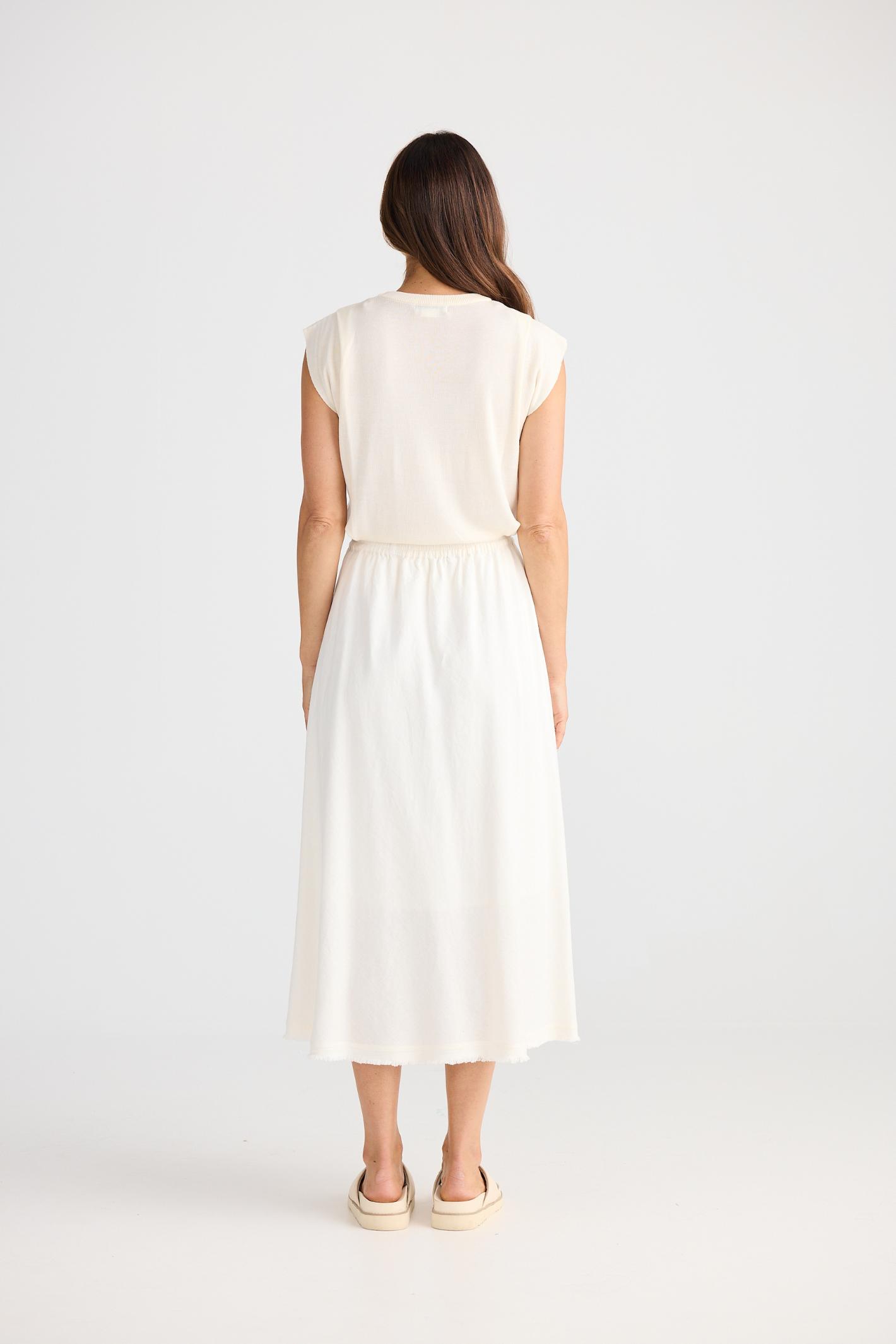 Brave + True Oakley Skirt in off white. Bias-cut midi skirt with elasticated waist, side splits and linen viscose fabric. Shop at Dotique.