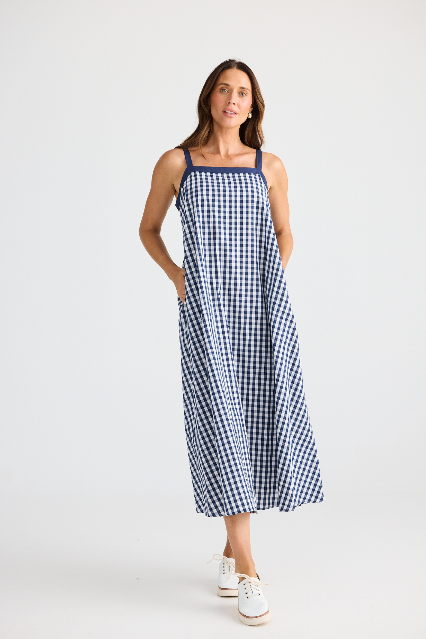 Brave + True Erica Dress in navy gingham. Cotton midi dress with shoulder straps, back tie detail and relaxed fit. Shop Brave + True at Dotique.