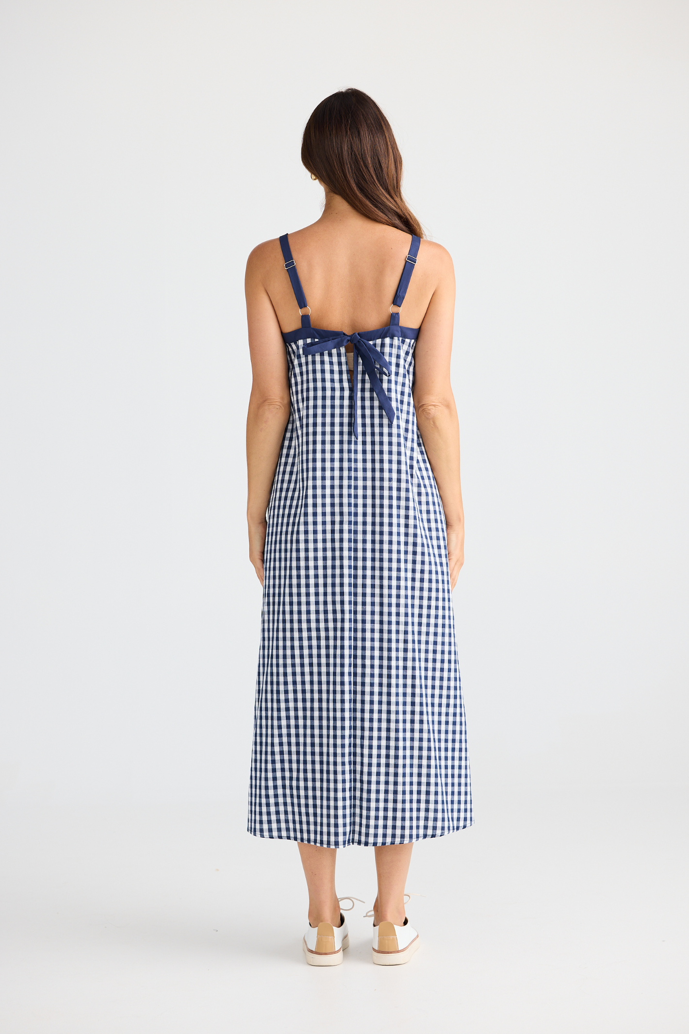 Brave + True Erica Dress in navy gingham. Cotton midi dress with shoulder straps, back tie detail and relaxed fit. Shop Brave + True at Dotique.