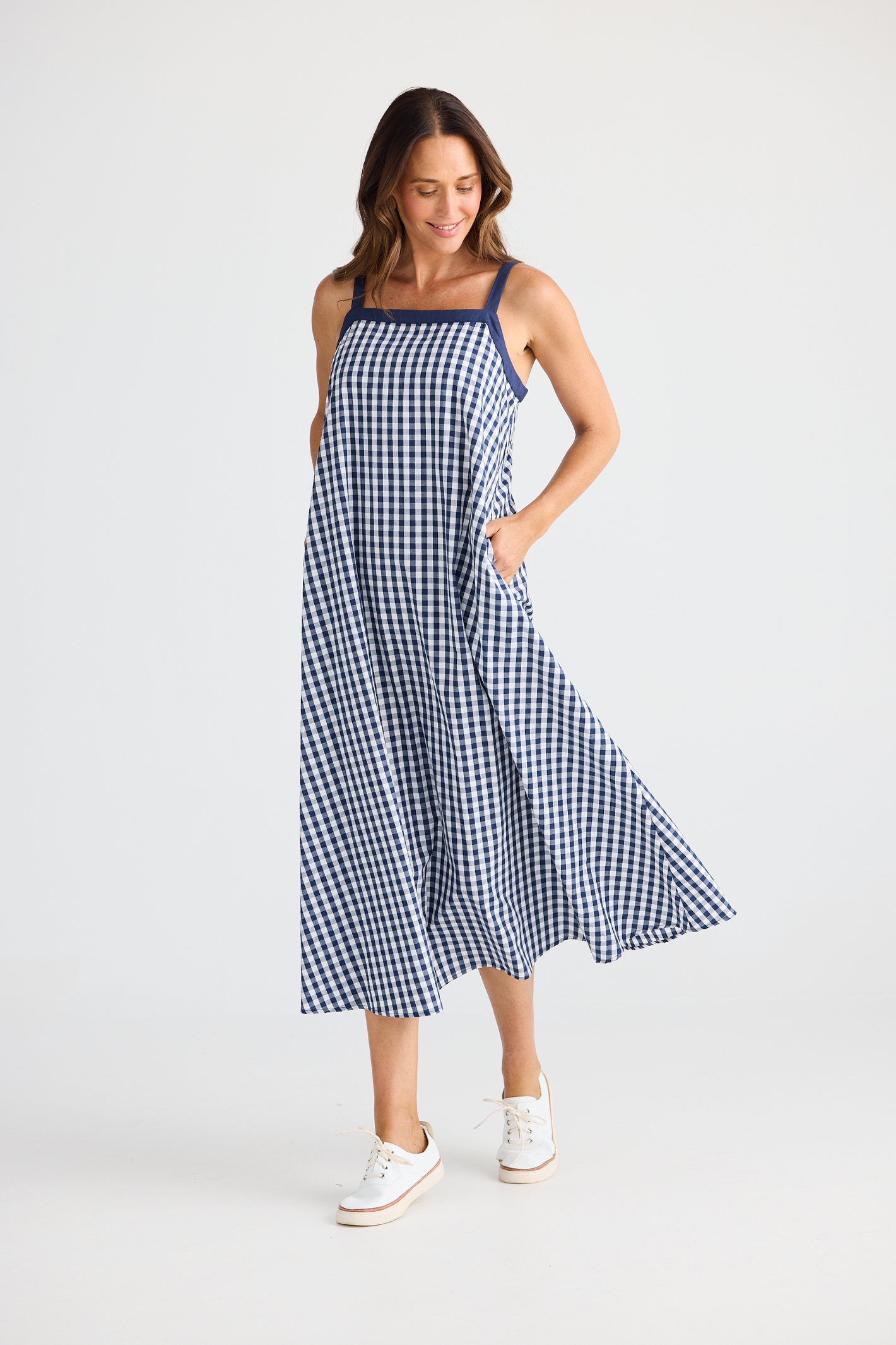 Brave + True Erica Dress in navy gingham. Cotton midi dress with shoulder straps, back tie detail and relaxed fit. Shop Brave + True at Dotique.