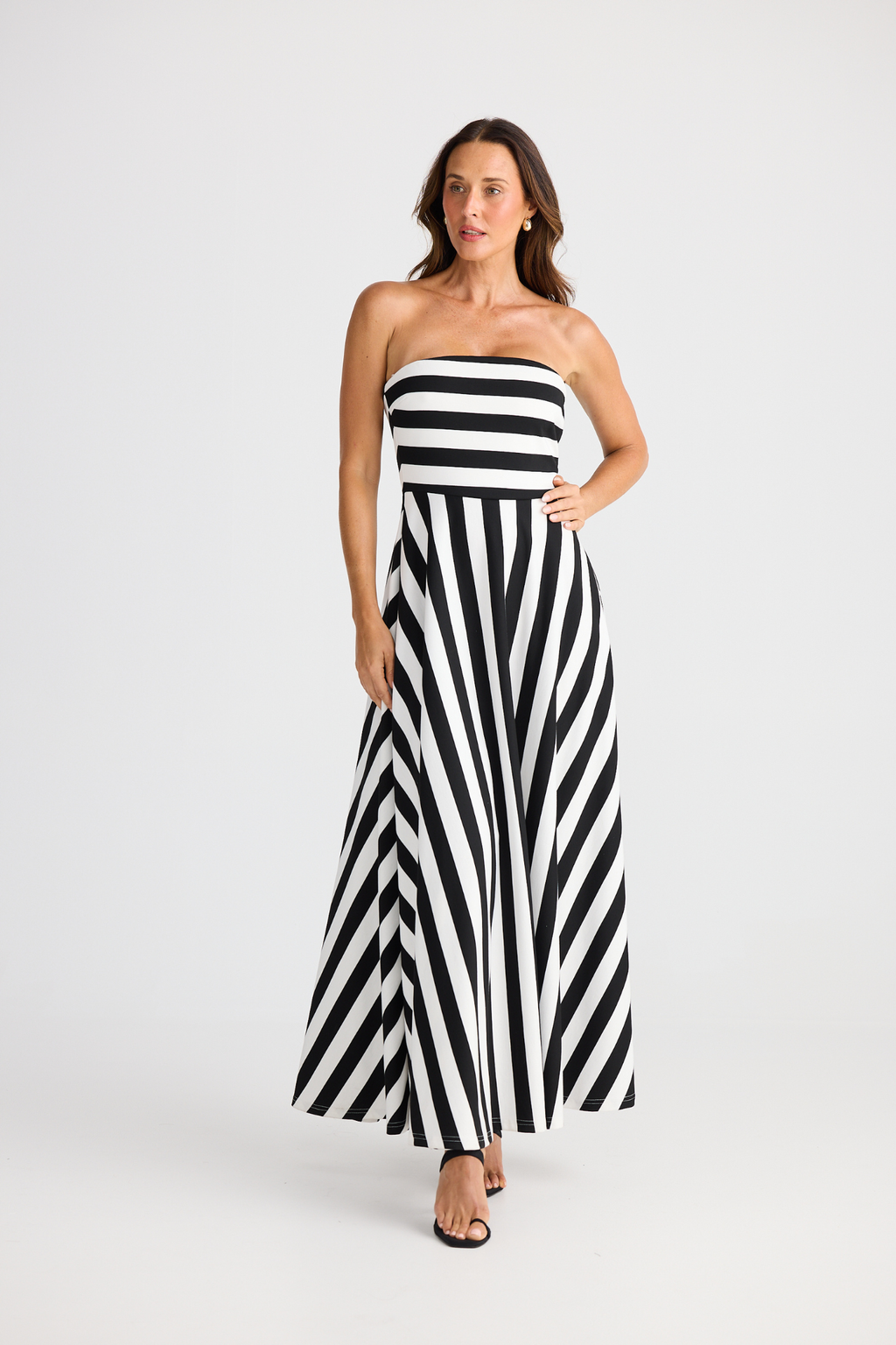 Brave + True Thandie Strapless Dress in black wide stripe. Full-length jersey ponte dress with flared skirt. Shop at Dotique.
