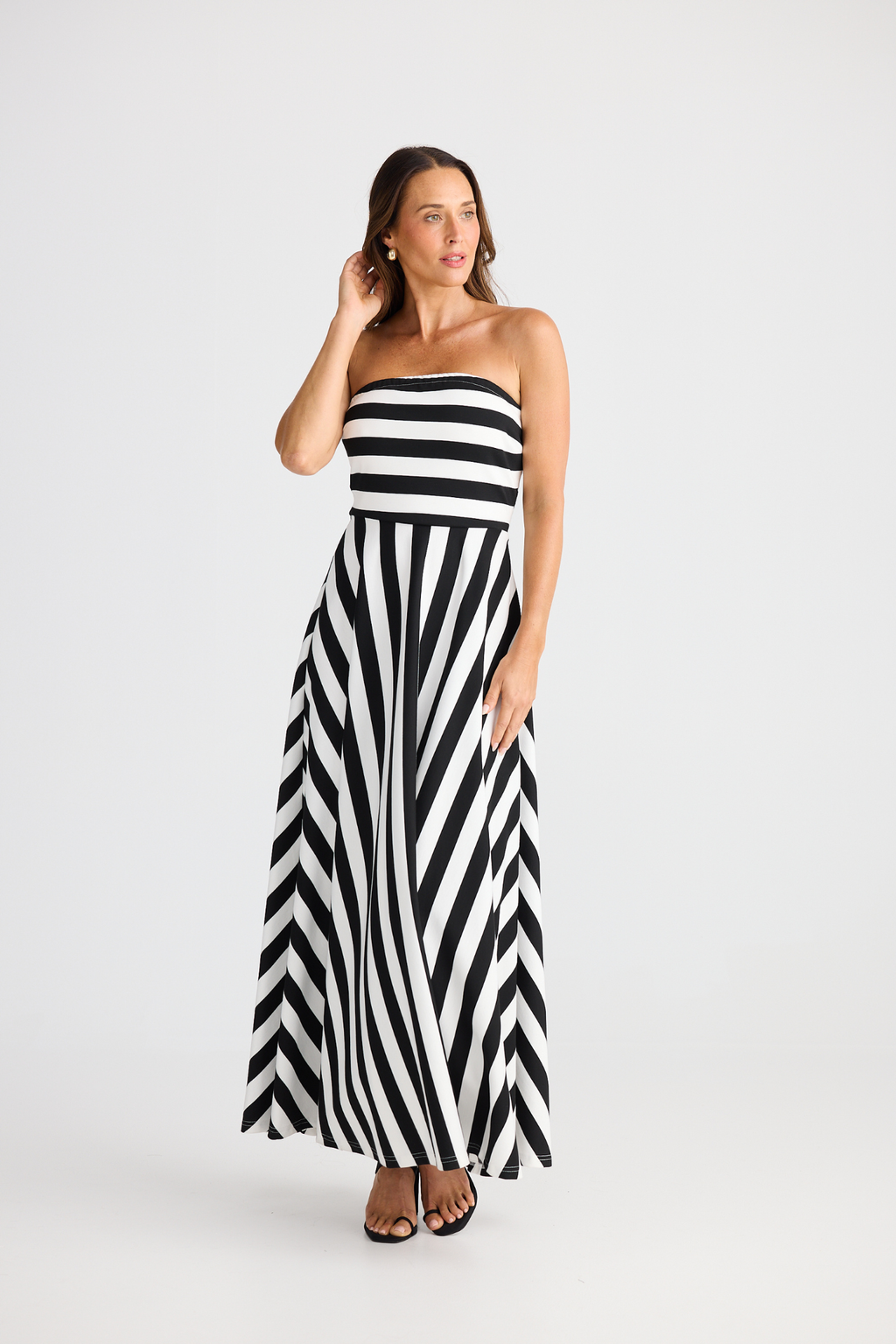 Brave + True Thandie Strapless Dress in black wide stripe. Full-length jersey ponte dress with flared skirt. Shop at Dotique.