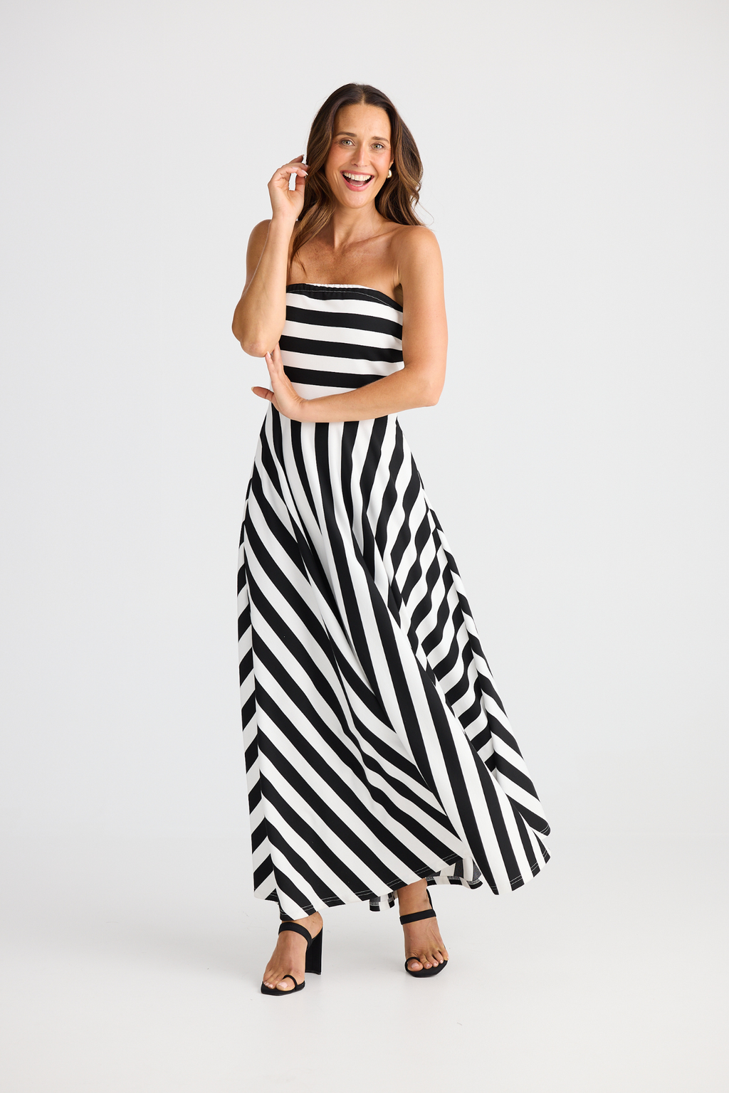 Brave + True Thandie Strapless Dress in black wide stripe. Full-length jersey ponte dress with flared skirt. Shop at Dotique.