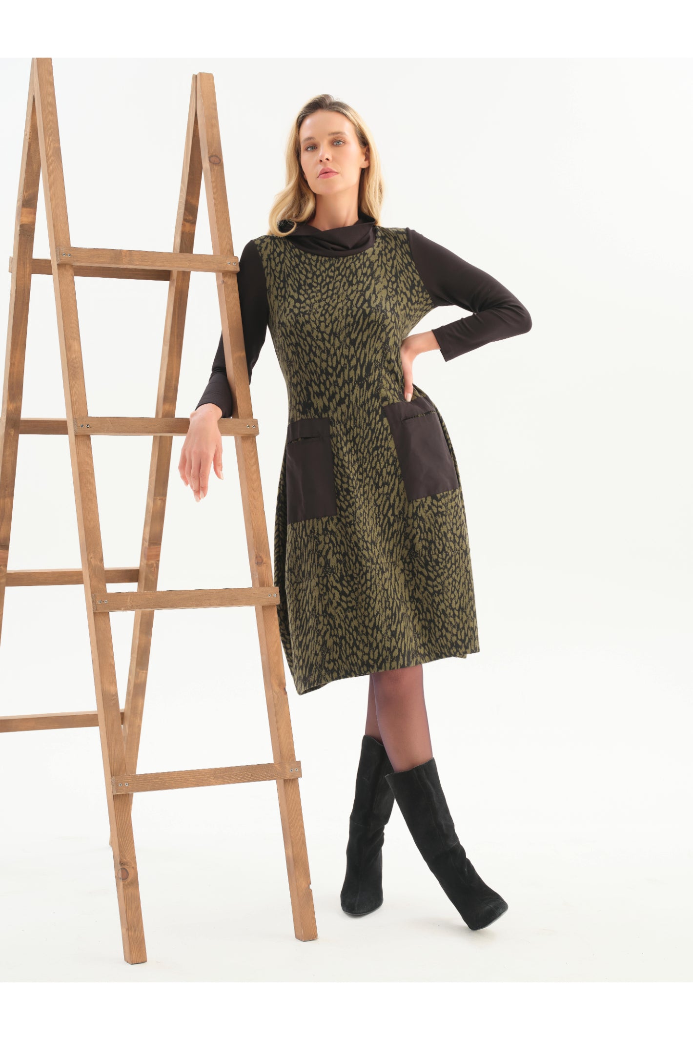 Dotique Dolcezza 76114 assorted abstract print knit dress with a roll neckline, contrast black sleeves and front patch pockets.