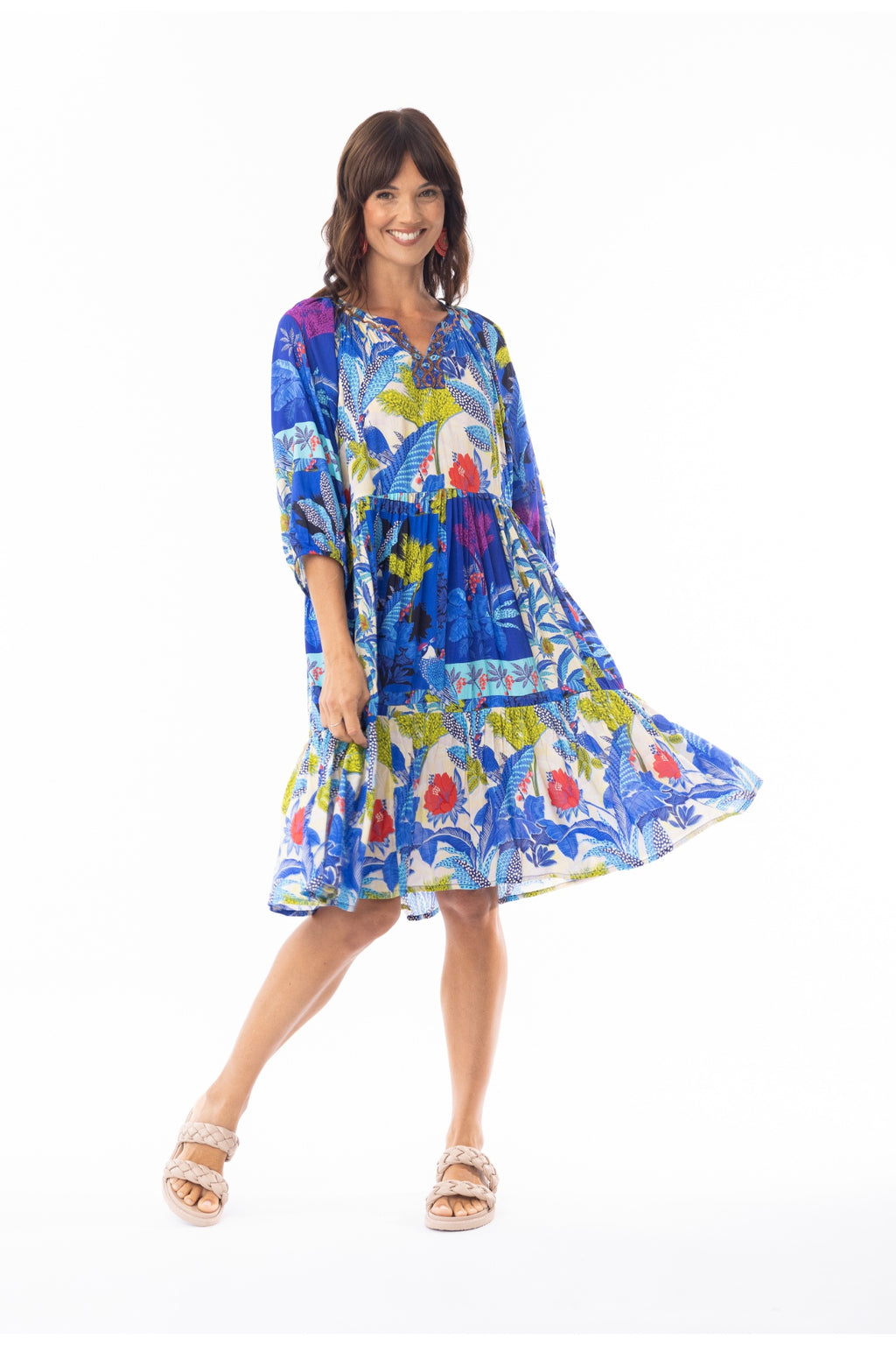 Smiling woman twirling in vibrant Escape 30120 Luna Dress V Print by Escape, shop Escape at Dotique