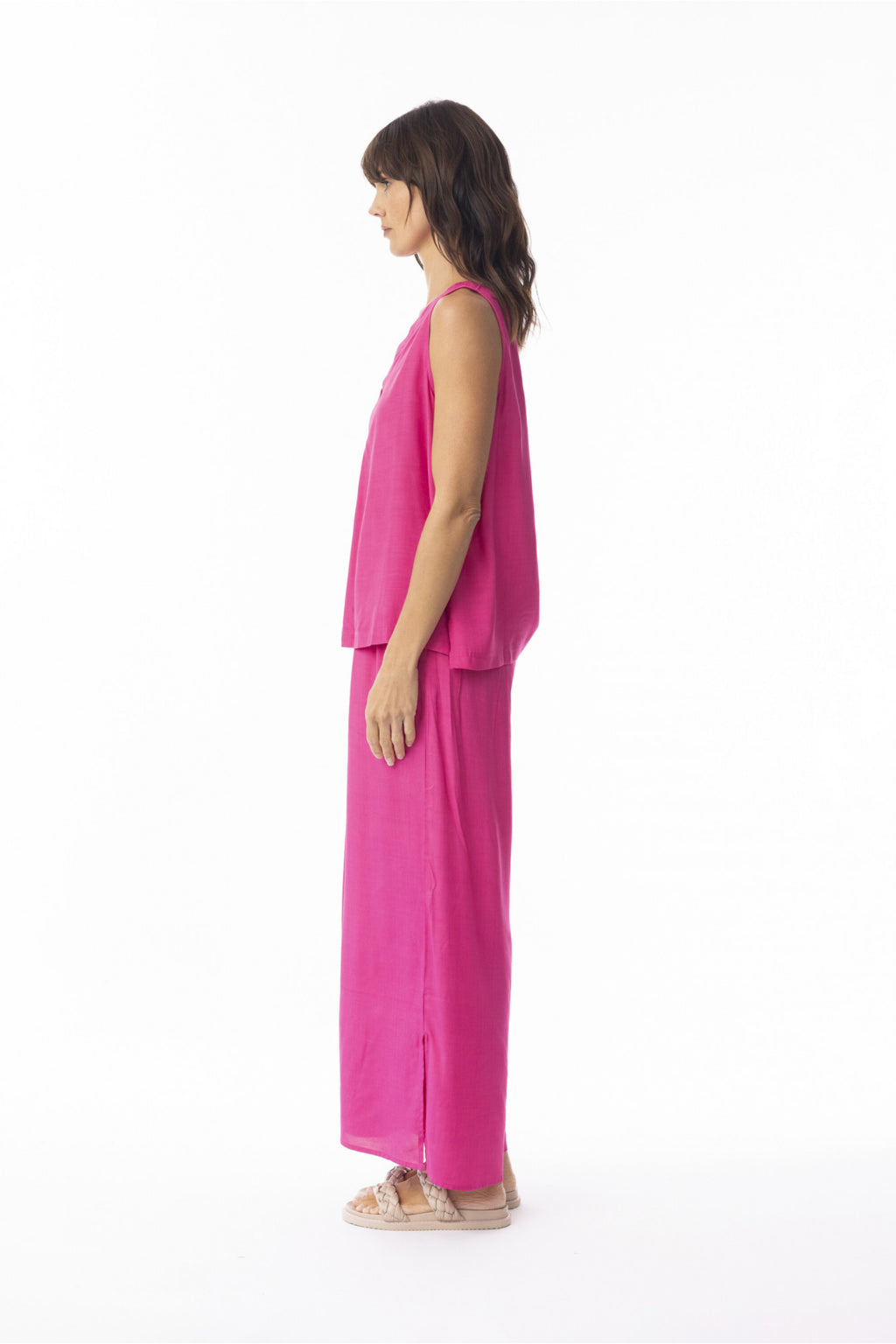Side profile of model wearing Escape 56216 Lux Wide Leg Trousers Hot Pink by Escape Shop Escape at Dotique