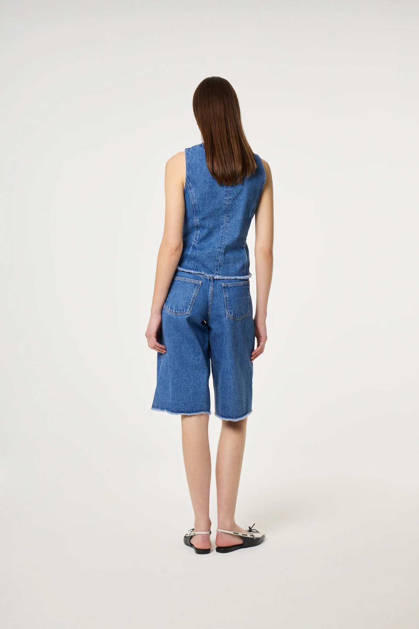 Model seen from the back wearing Fabienne Chapot Jojo Top Faded Light Blue paired with denim shorts by Fabienne Chapot, shop Fabienne Chapot at Dotique.