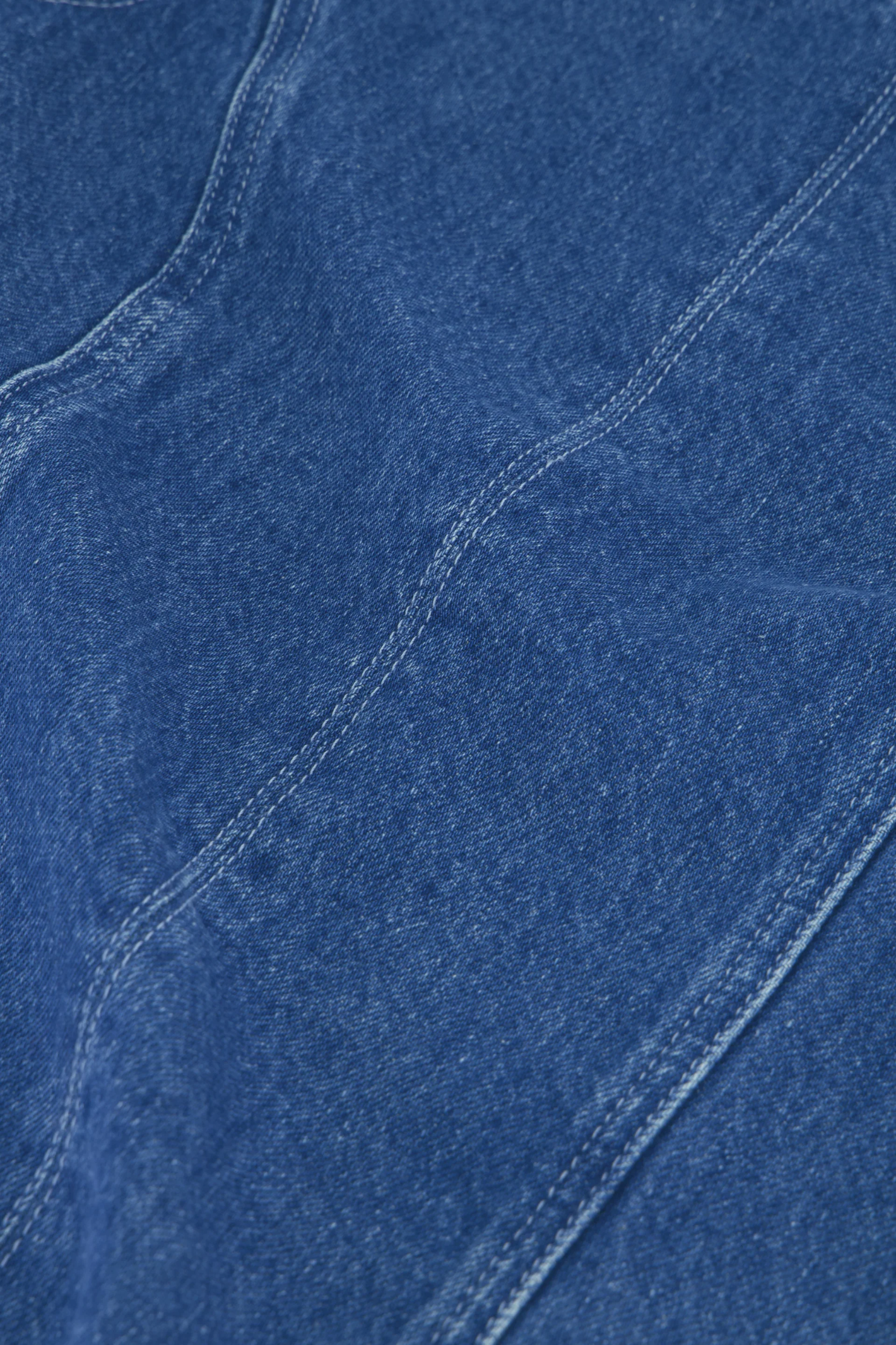 Close-up of denim fabric details featuring stitching and texture, highlighting Fabienne Chapot Jojo Top Faded Light Blue by Fabienne Chapot, shop Fabienne Chapot at Dotique.