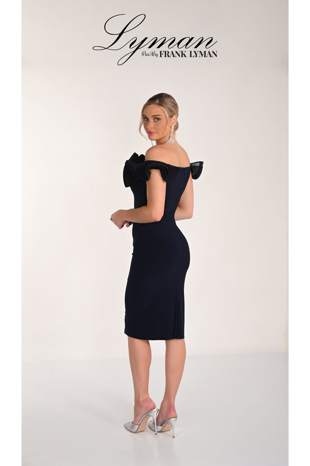 Elegant model wearing Frank Lyman 268015 Midnight Off-Shoulder Ruffle Dress by Frank Lyman Shop Frank Lyman at Dotique