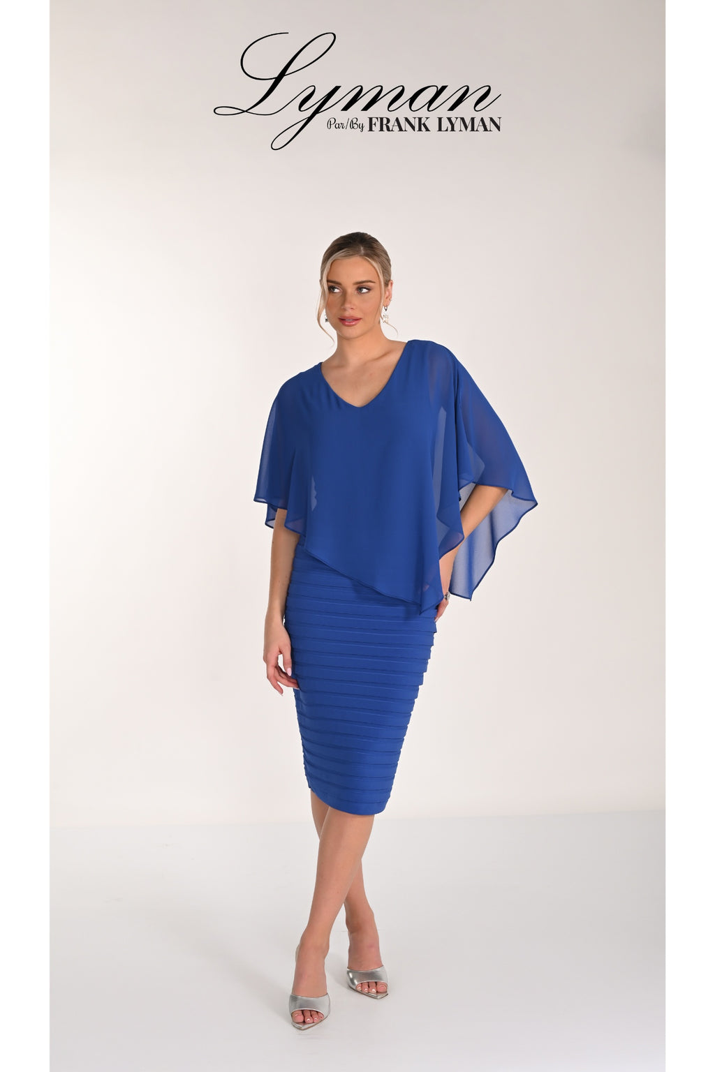 Woman modeling Frank Lyman 268023 Royal Blue Chiffon Overlay Dress by Frank Lyman Shop Frank Lyman at Dotique