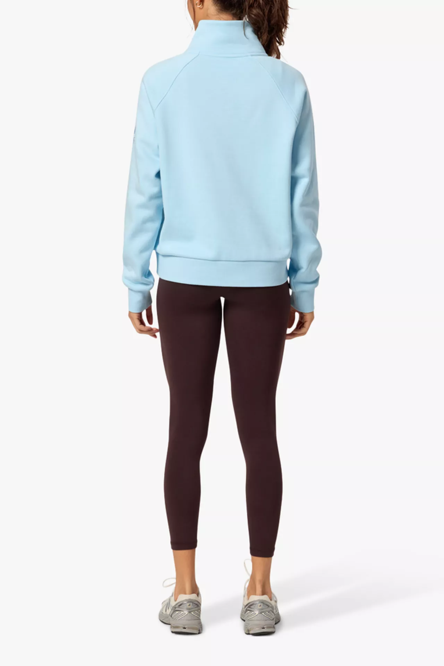 Back view of a woman wearing Gym+Coffee Clubhouse Quarter Zip in Baby Blue by Gym+Coffee, shop Gym+Coffee at Dotique.