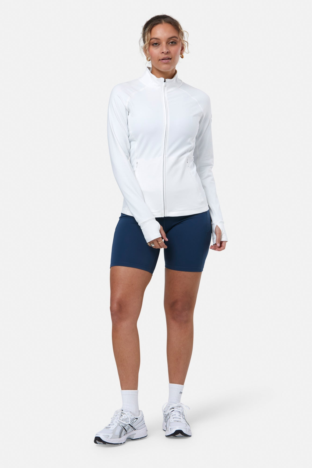 Woman wearing Gym+Coffee Relentless Full Zip Jacket in Ultra White by Gym+Coffee, shop Gym+Coffee at Dotique online.