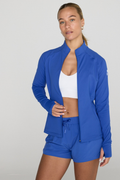 Woman wearing Gym+Coffee Relentless Full Zip Tidal Blue jacket by Gym+Coffee, shop Gym+Coffee at Dotique.