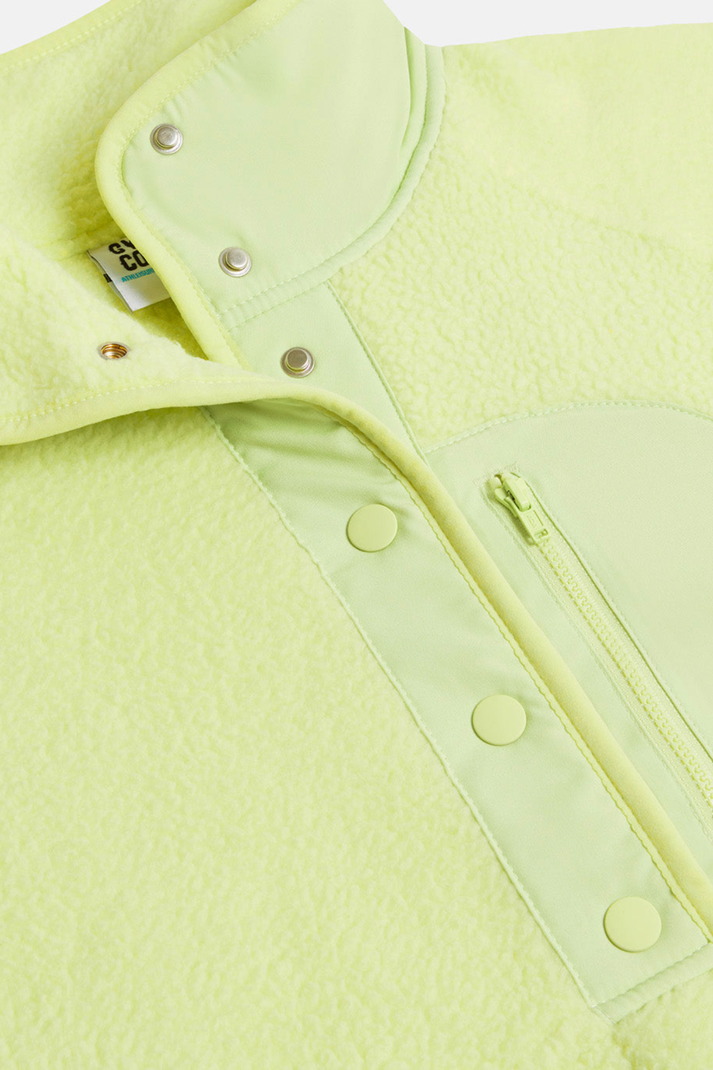 Close-up of Gym + Coffee Horizon Layer Up Jacket in in Lime Sorbet by Gym+Coffee, available to shop at Dotique.