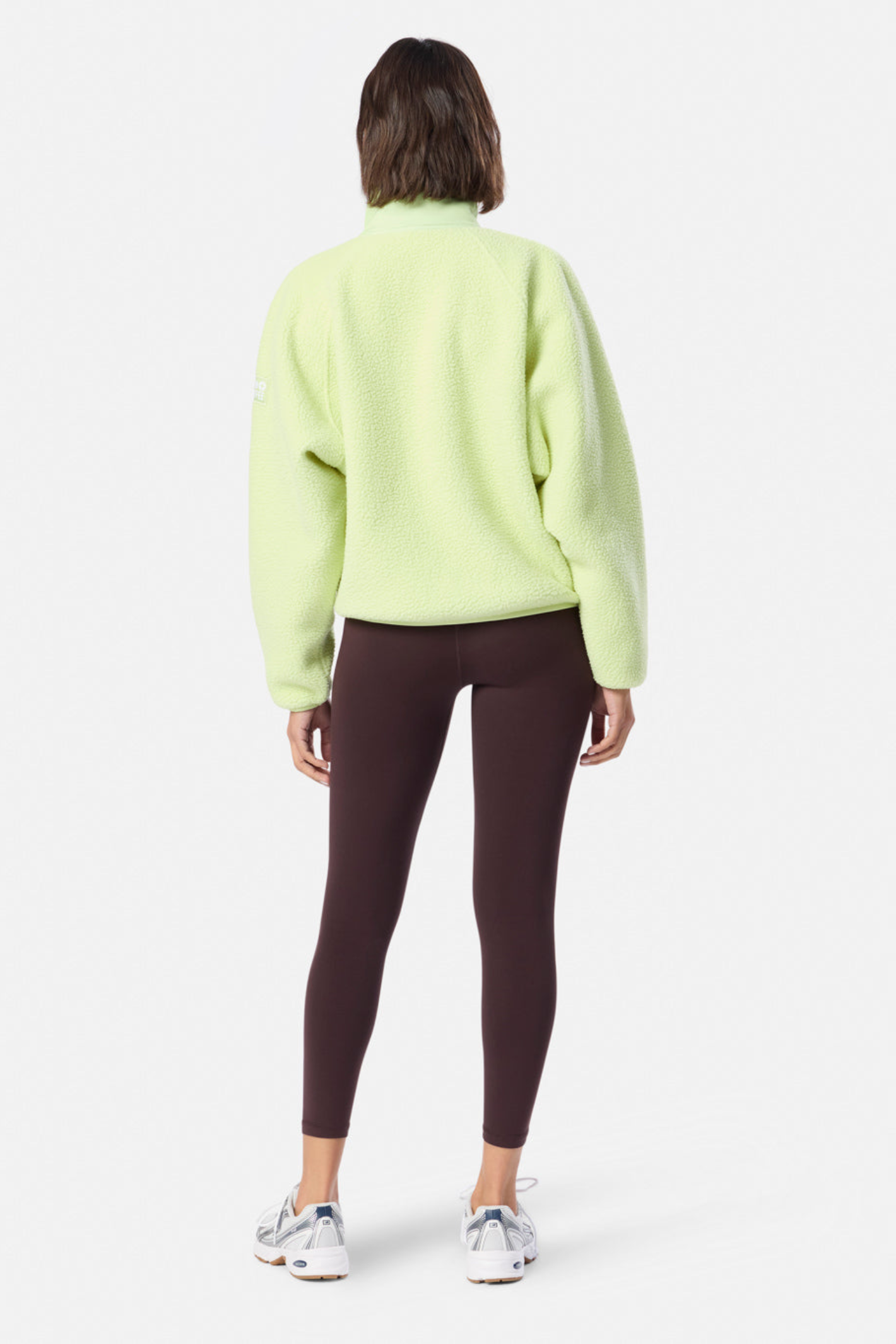 Back view of a model wearing Gym + Coffee Horizon Layer Up Jacket in Lime Sorbet by Gym+Coffee, shop Dotique.