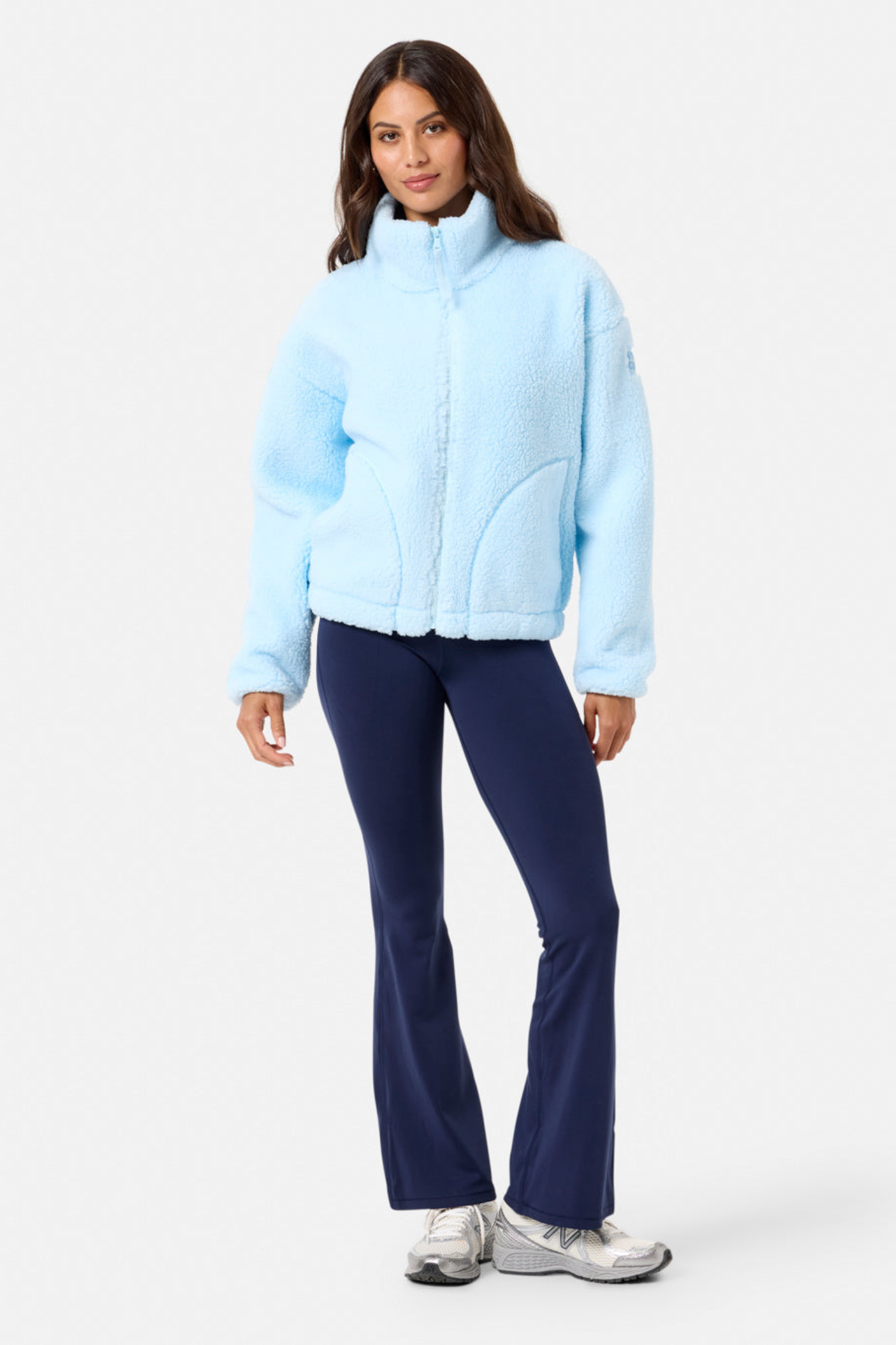 Woman wearing Gym+Coffee Industry Fleece High Collar Jacket in Baby Blue by Gym+Coffee Shop at Dotique
