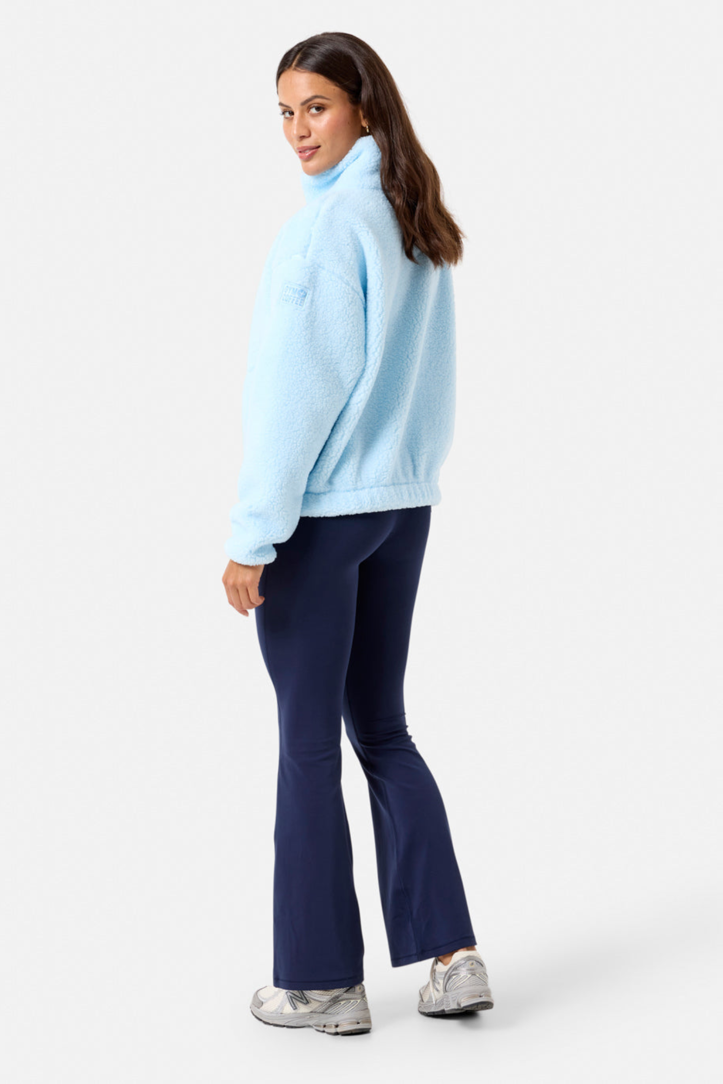 Woman wearing Gym+Coffee Industry Fleece High Collar Jacket in Baby Blue by Gym+Coffee, shop the vendor at Dotique