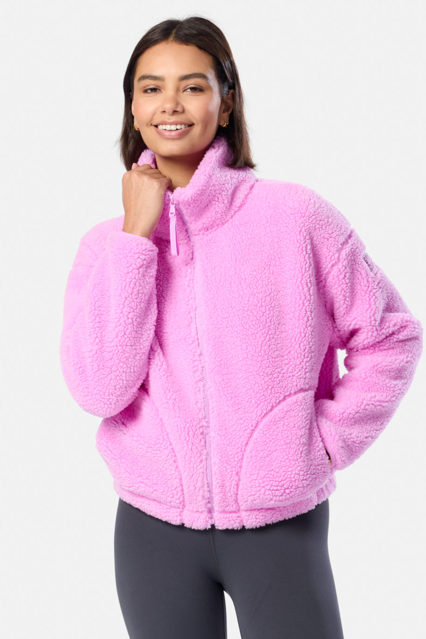 Woman wearing Gym+Coffee Industry Fleece High Collar Jacket in Neon Pink by Gym+Coffee shop at Dotique in cozy sporty style