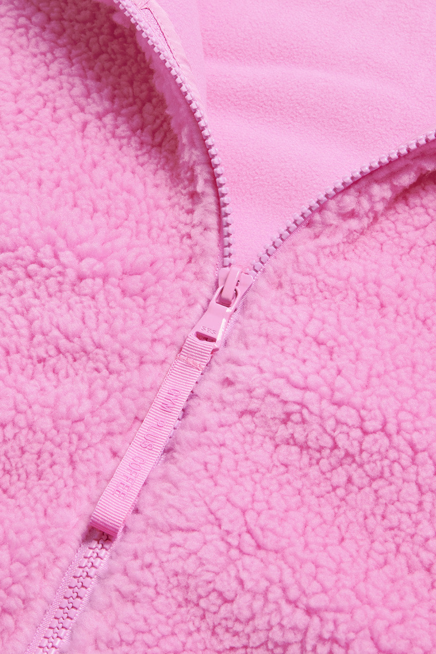 Close-up of the Gym+Coffee Industry Fleece High Collar Jacket in Neon Pink zipper and fleece texture, shop Gym+Coffee at Dotique