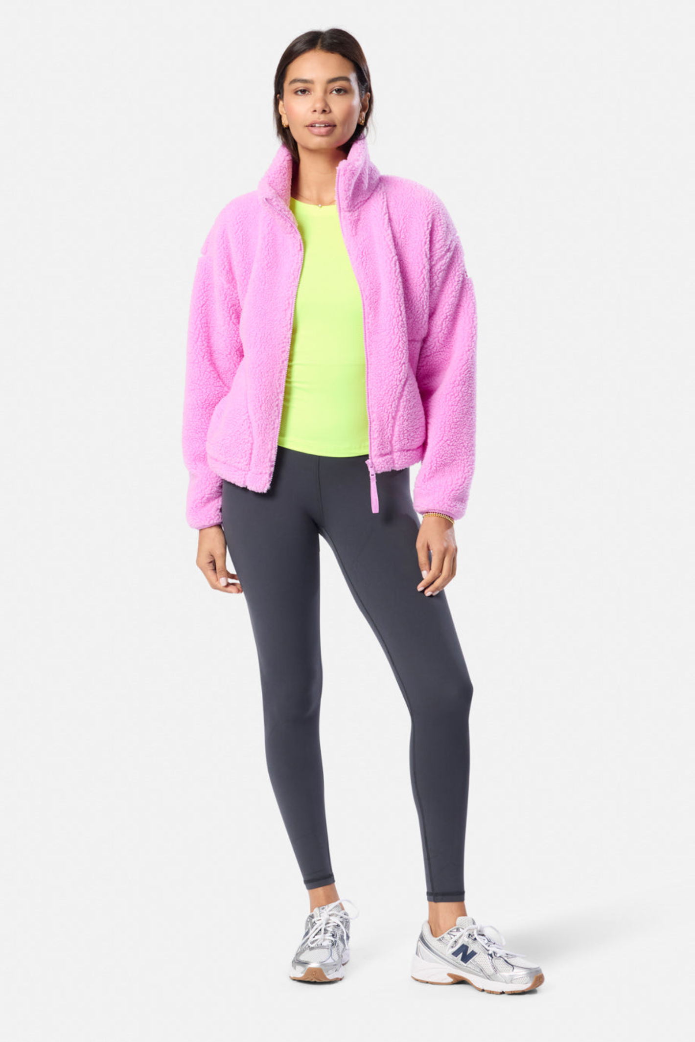 Woman wearing Gym+Coffee Industry Fleece High Collar Jacket in Neon Pink with leggings and sneakers Shop Gym+Coffee at Dotique