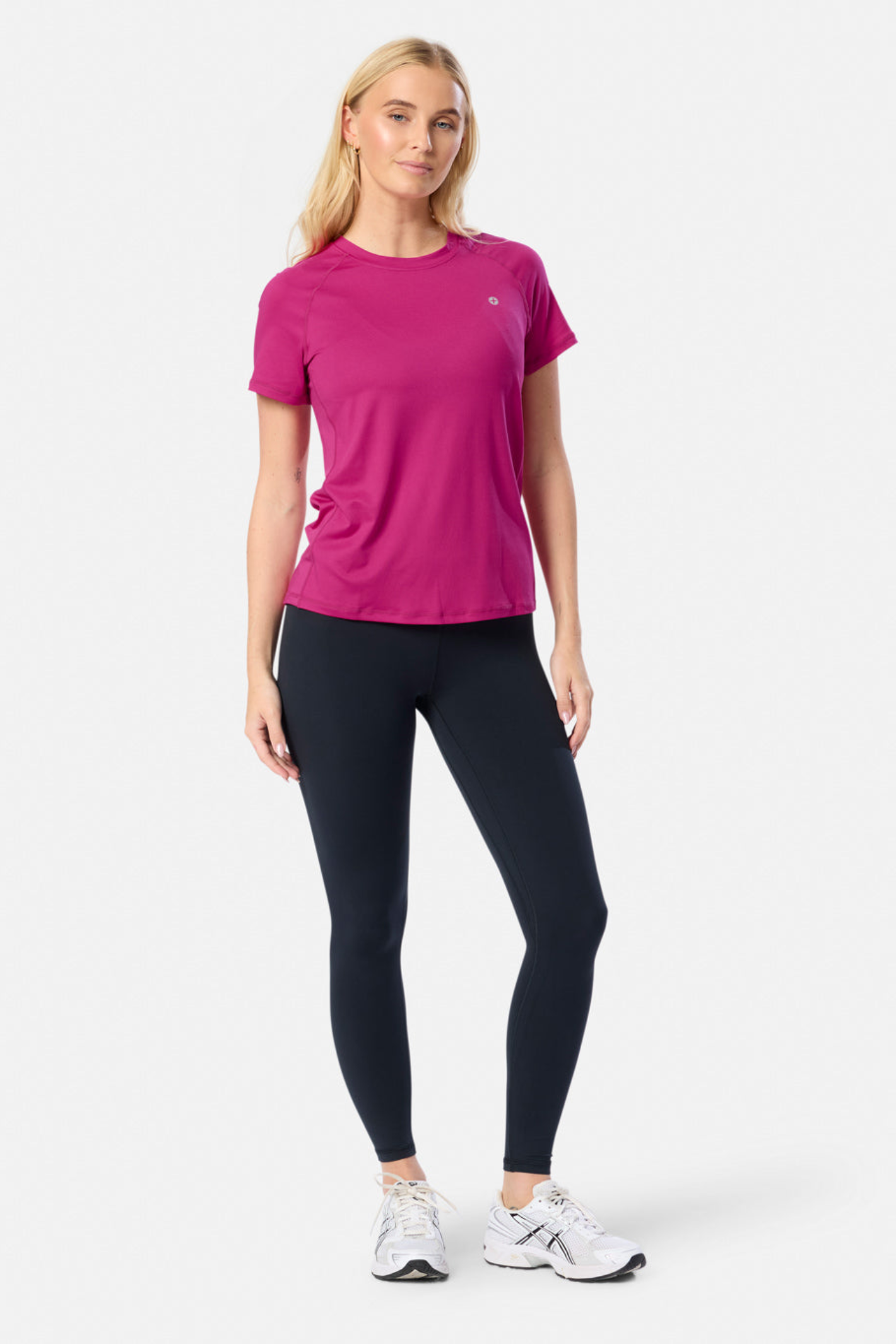 Model wearing Gym+Coffee Relentless Tee in Sunrise Pink by Gym+Coffee, shop the vendor Dotique for lightweight activewear essentials.