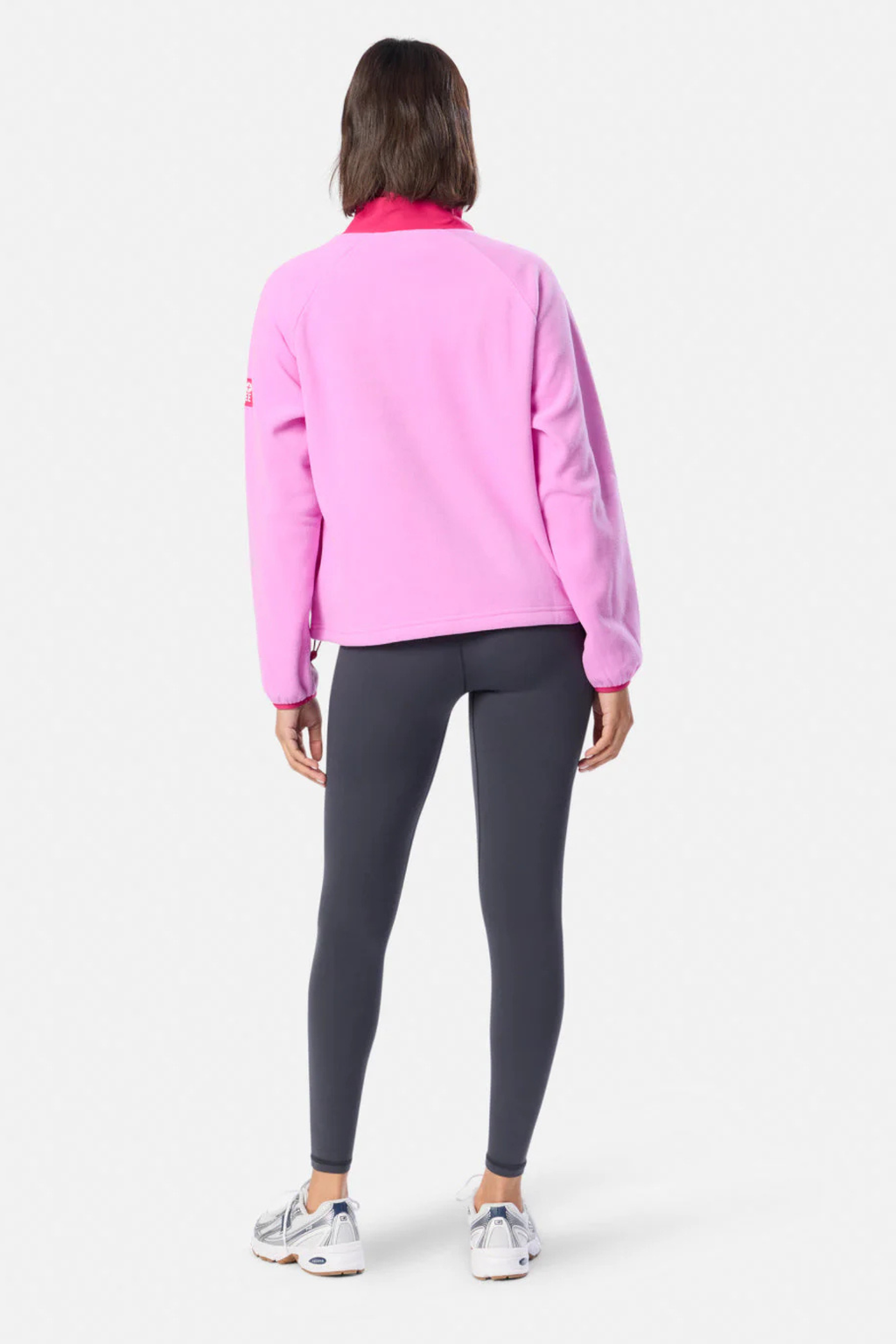 Rear view of model wearing Gym+Coffee Snap Polar Fleece Neon Pink by Gym+Coffee Shop Gym+Coffee at Dotique