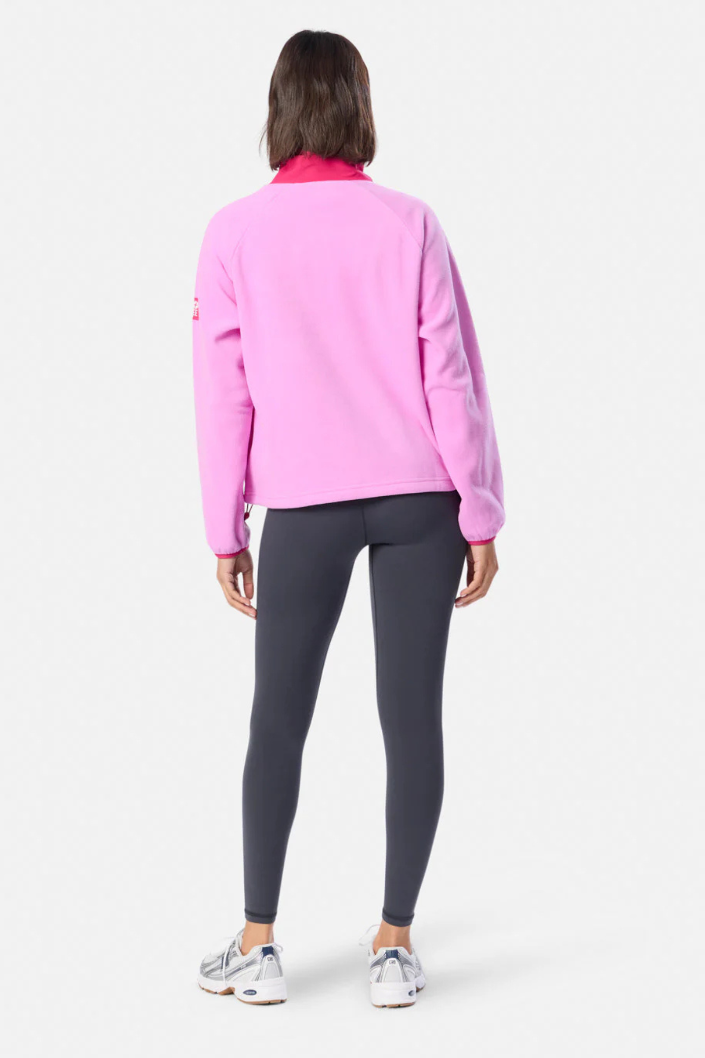 Rear view of model wearing Gym+Coffee Snap Polar Fleece Neon Pink by Gym+Coffee Shop Gym+Coffee at Dotique