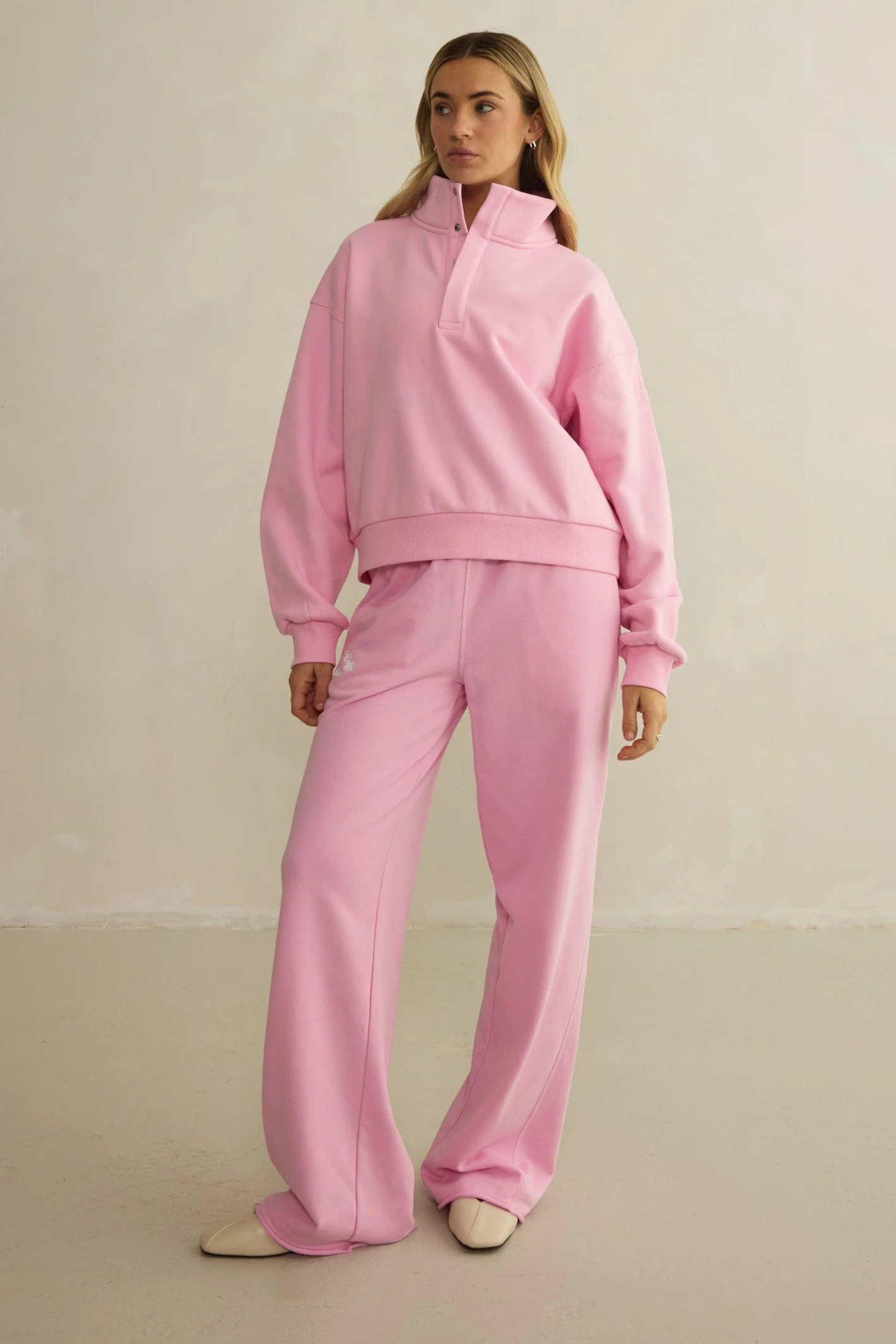 Model styled in Gym+Coffee Urban Wide Leg Jogger in Pink Blossom by gym+coffee, shop gym+coffee at Dotique.