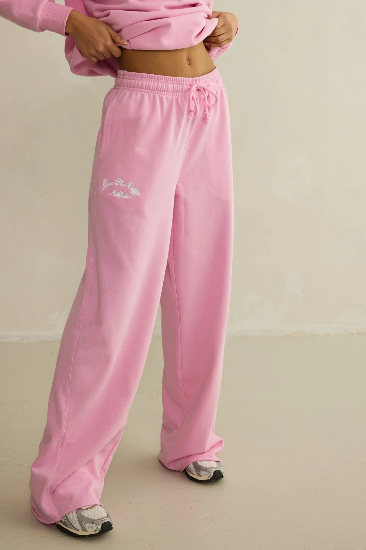 Gym+Coffee Urban Wide Leg Jogger in Pink Blossom styled on model with visible logo by gym+coffee shop gym+coffee at Dotique