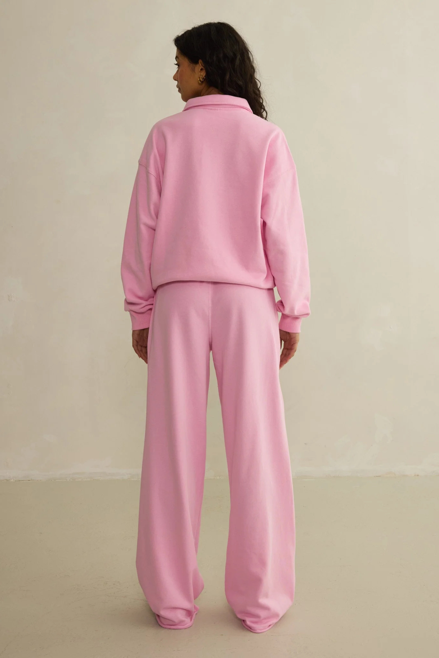 Model showcasing the back of Gym+Coffee Urban Wide Leg Jogger in Pink Blossom by gym+coffee, shop gym+coffee at Dotique