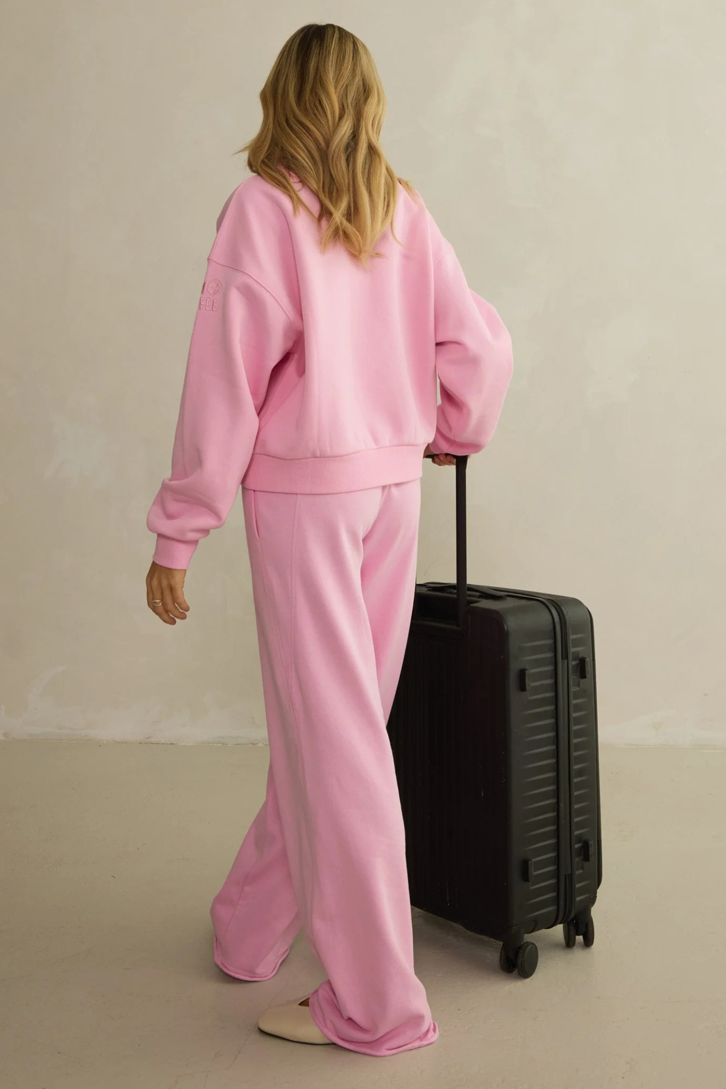 Back view of model wearing Gym+Coffee Urban Wide Leg Jogger in Pink Blossom by gym+coffee, shop gym+coffee at Dotique