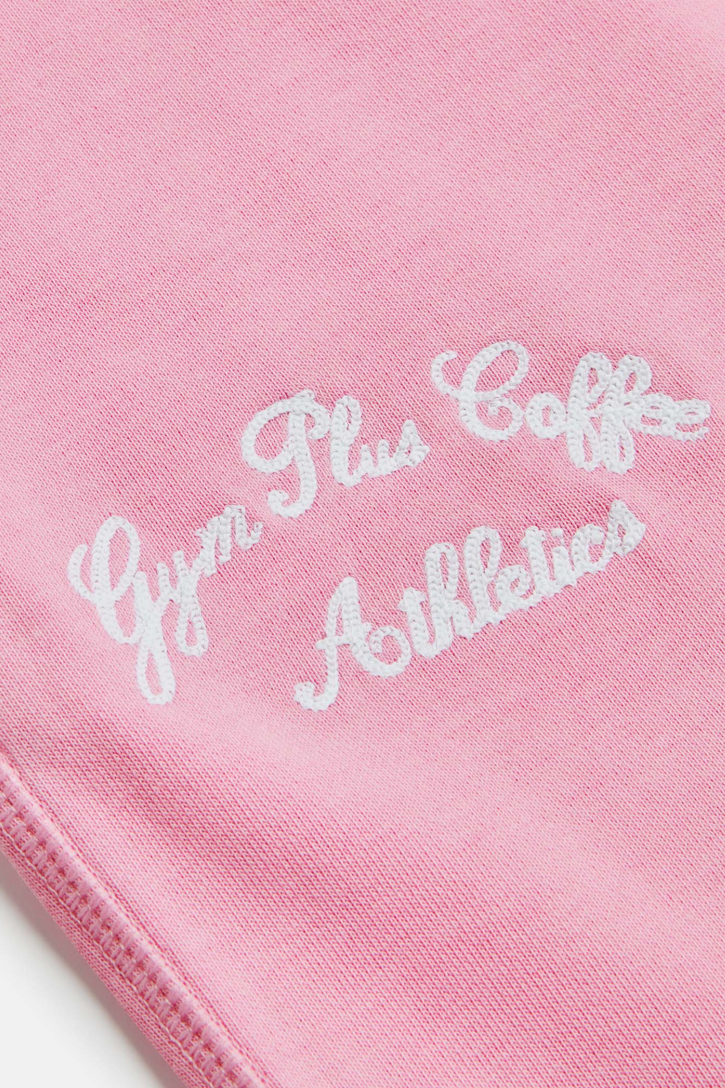 Close-up of embroidery detail on Gym+Coffee Urban Wide Leg Jogger in Pink Blossom by gym+coffee, shop gym+coffee at Dotique