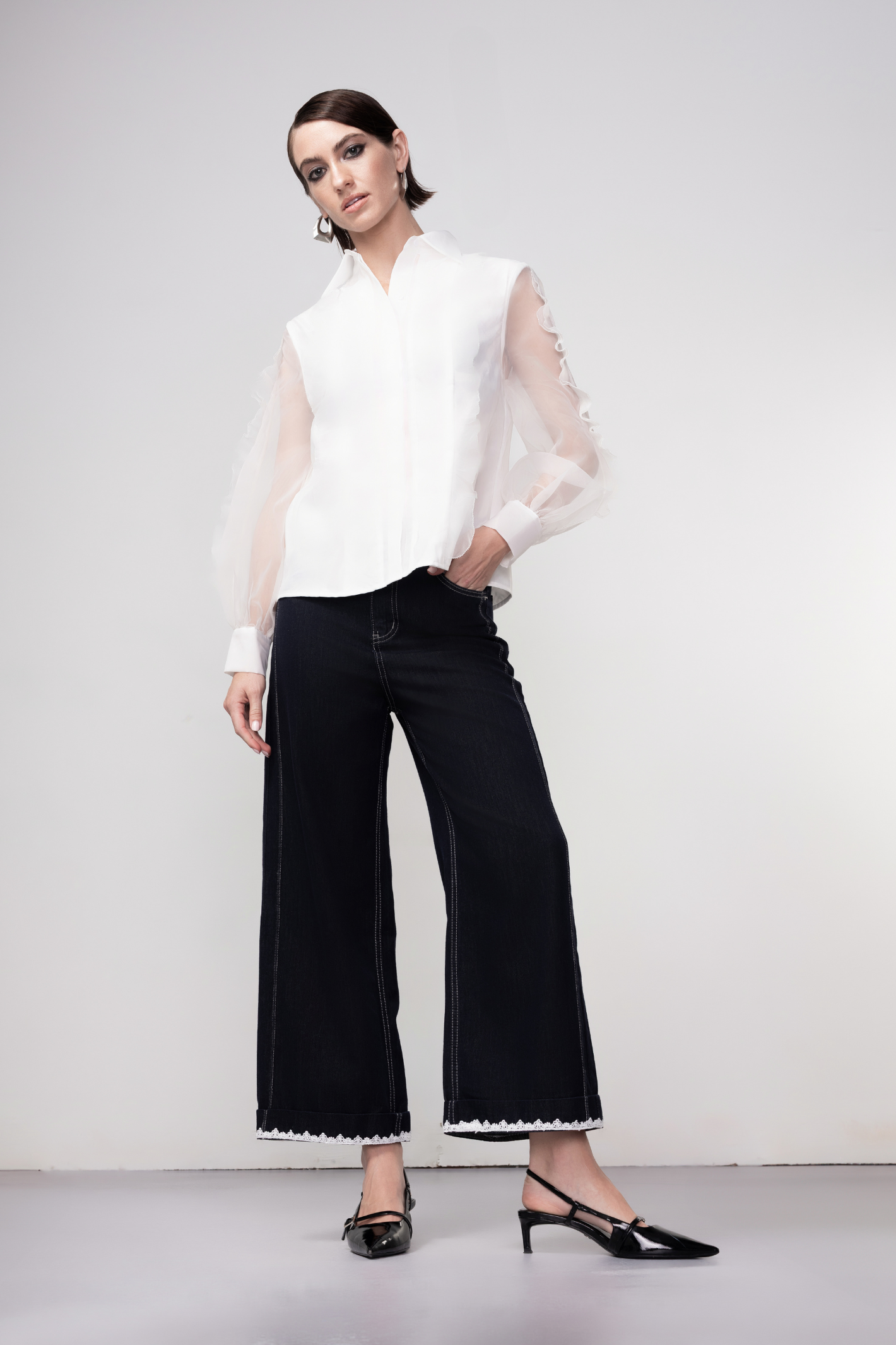 Haako dark blue wide leg jeans with contrast stitching and cream belt, styled for a modern minimalist look