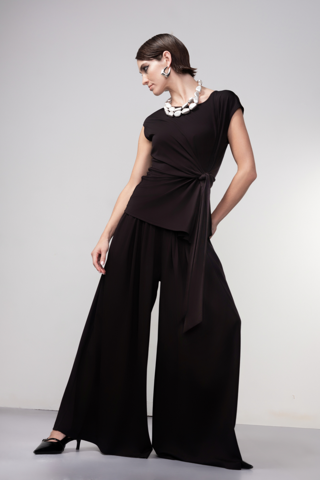 Haako black wide leg trousers with fluid drape and relaxed fit, styled for a modern minimalist look