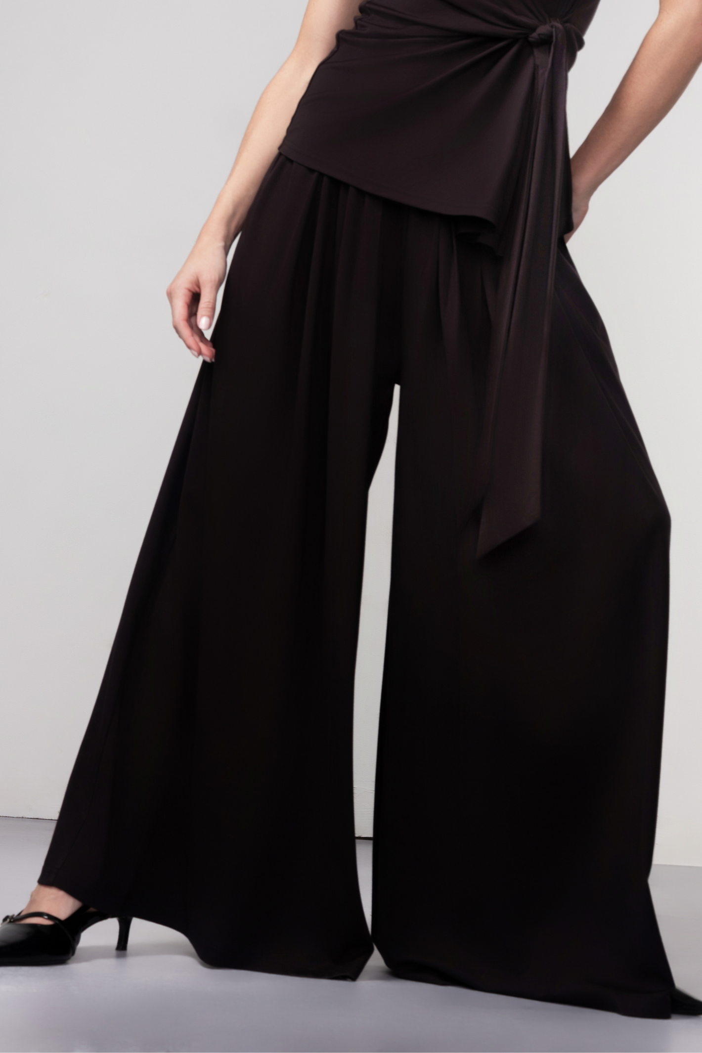 Haako black wide leg trousers with fluid drape and relaxed fit, styled for a modern minimalist look