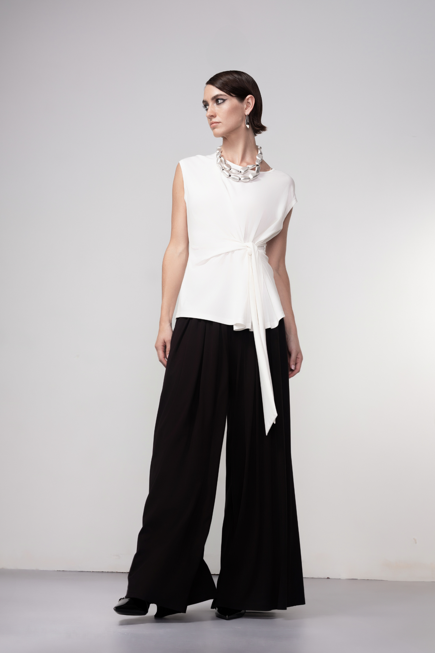 Haako black wide leg trousers with fluid drape and relaxed fit, styled for a modern minimalist look