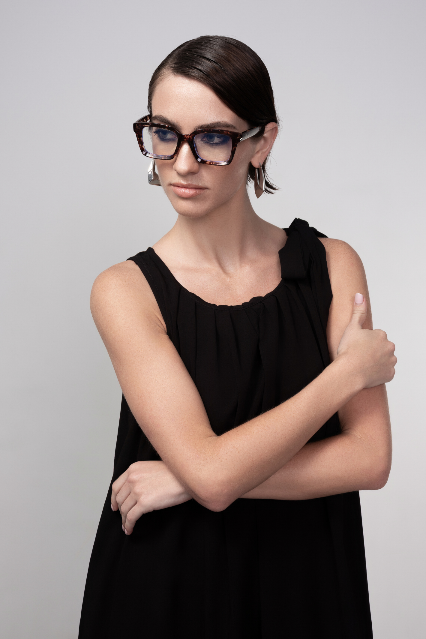 Haako black sleeveless midi dress with tie shoulder detail styled in a minimalist look at Dotique