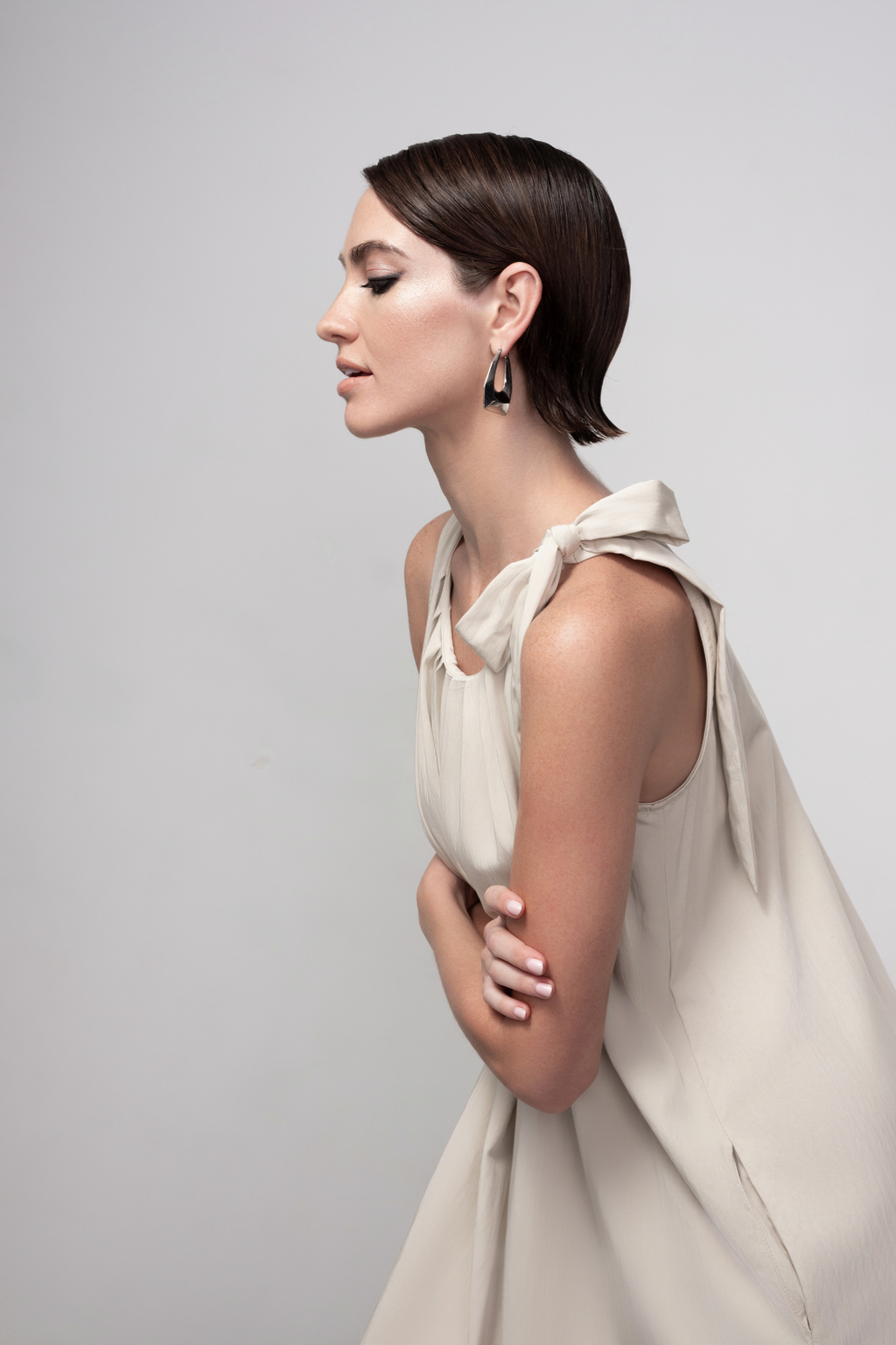 Haako stone sleeveless midi dress with tie shoulder detail styled in a minimalist look at Dotique