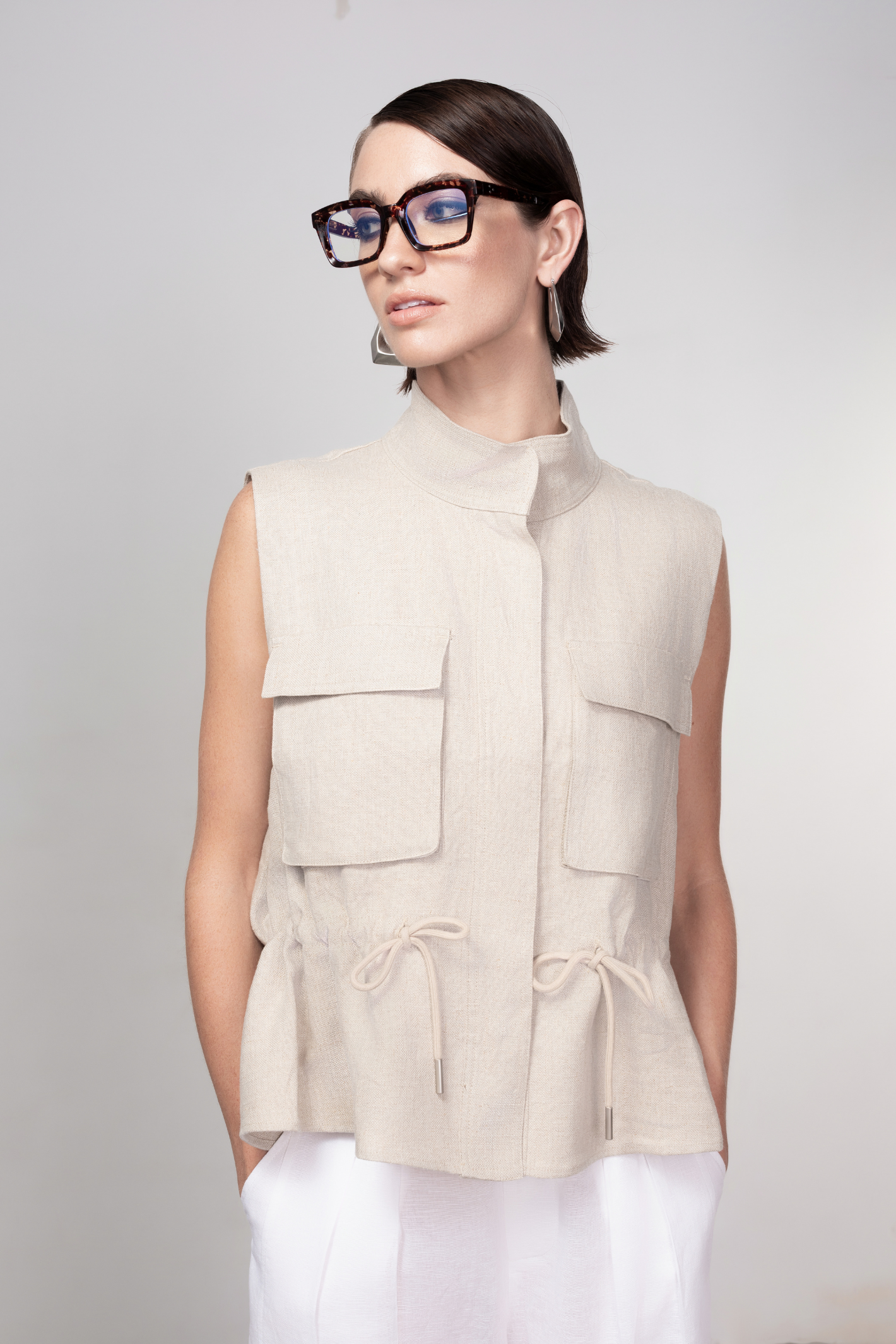 Haako sand linen utility vest styled in a relaxed modern look at Dotique