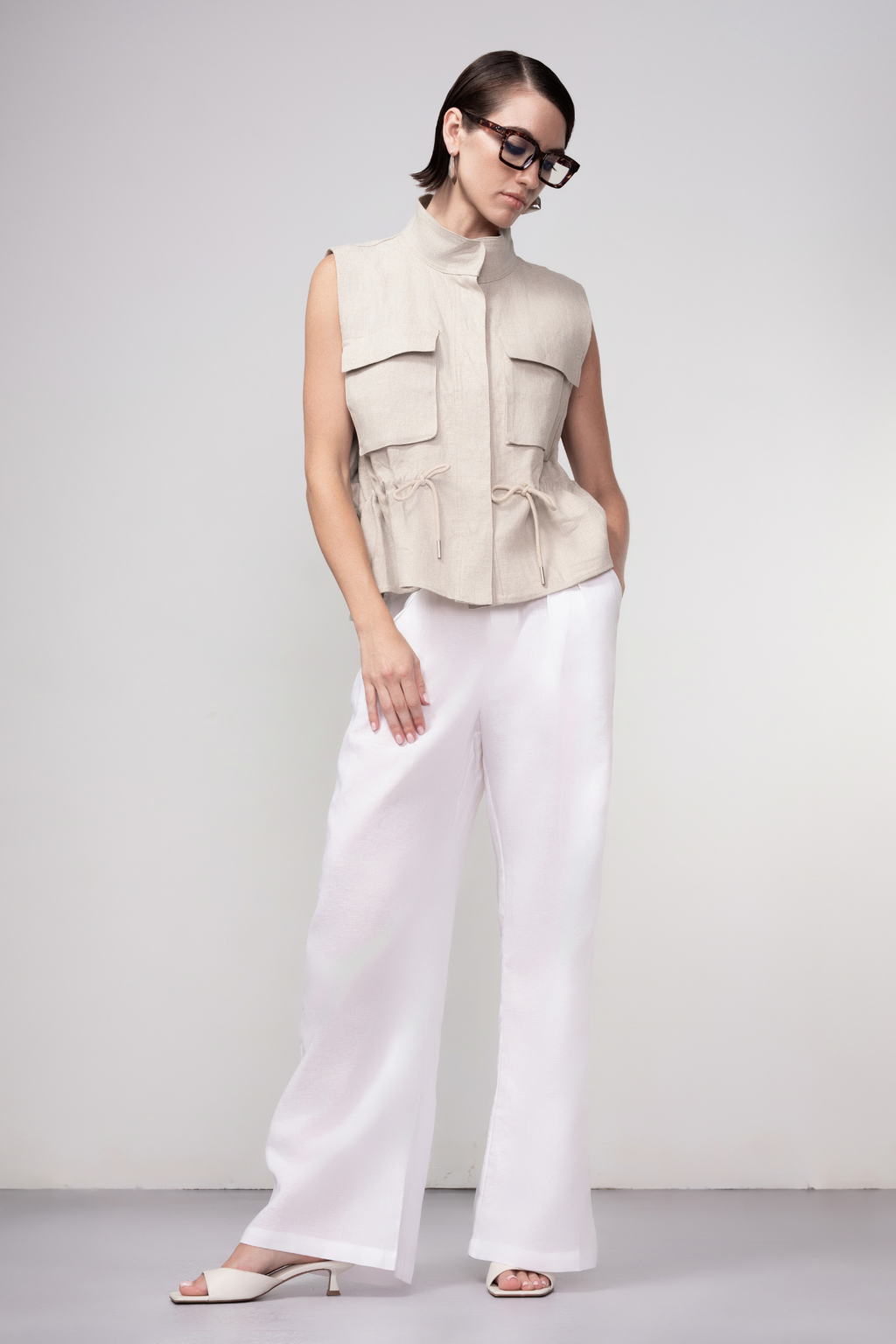 Haako sand linen utility vest styled in a relaxed modern look at Dotique